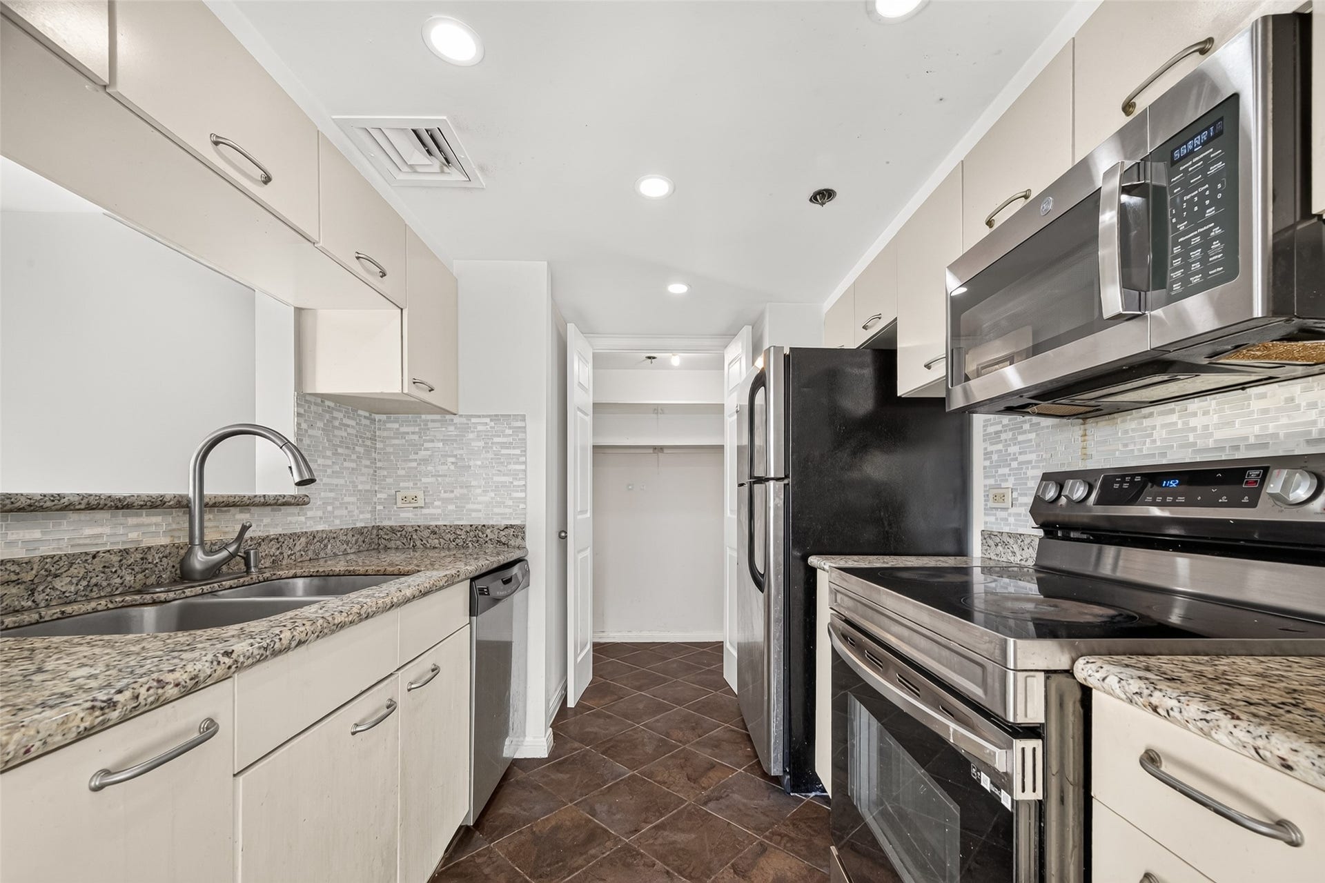 3525 Sage Road, #704, Houston, TX 77056 Kitchen opens up to living & dining room with stainless appliances, granite countertops and utility room. Refrigerator included