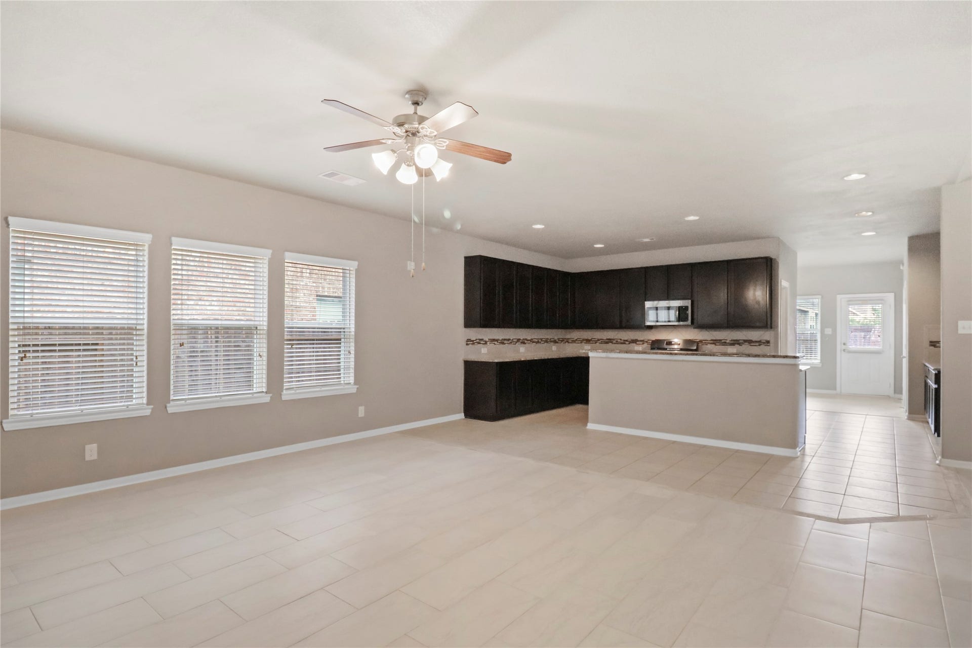 View of the kitchen space and windows in the living room