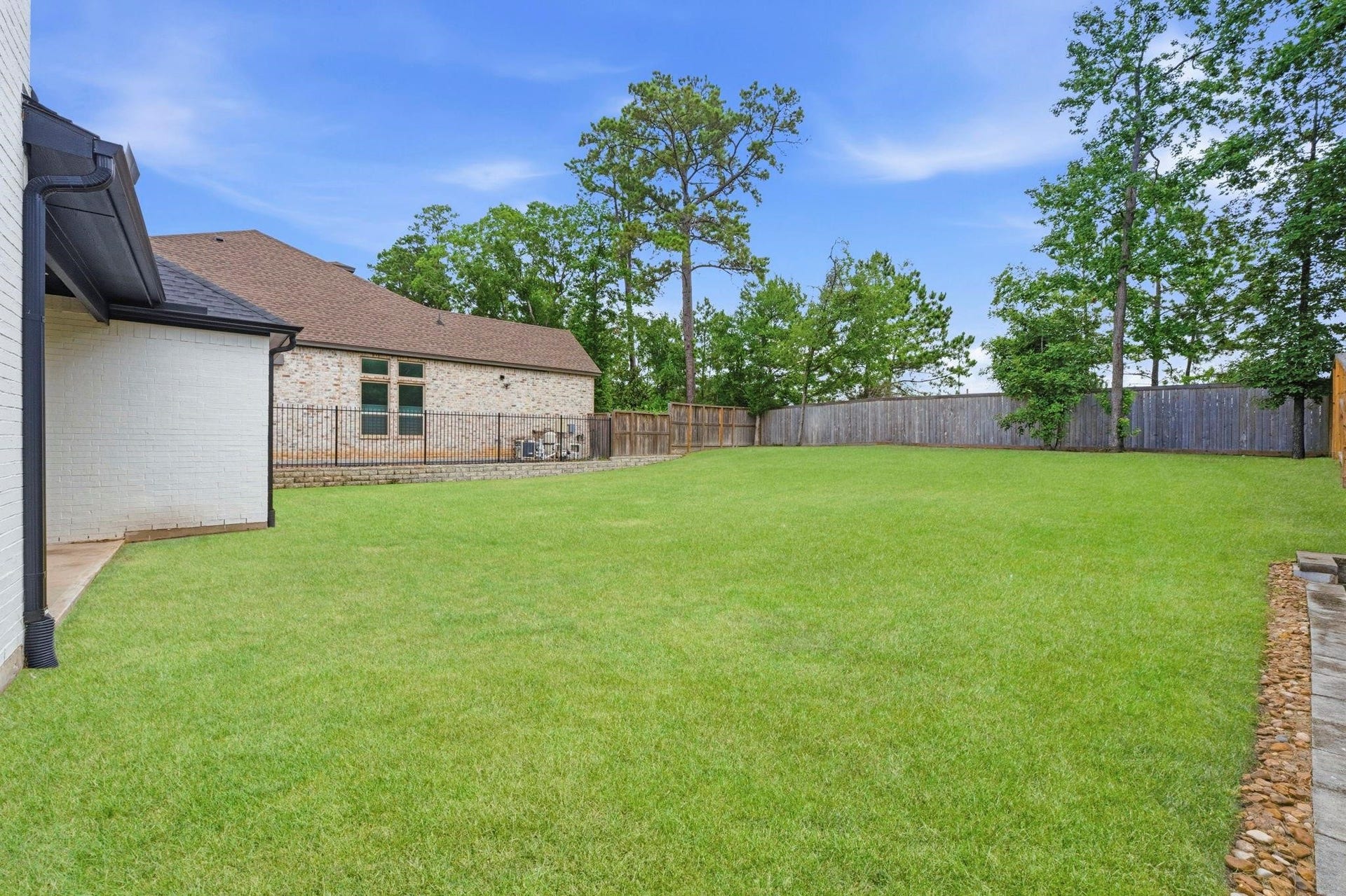 1715 Divino Pass, Conroe, TX 77304 An expansive, fully fenced backyard
featuring a massive lush green lawn,
mature trees along the perimeter,
and plenty of space for outdoor living
or a future pool. This photo has been
digitally staged to illustrate the
possibilities of the homes aesthetic
and potential design. Some
furnishings and dcor shown are for
visual inspiration.