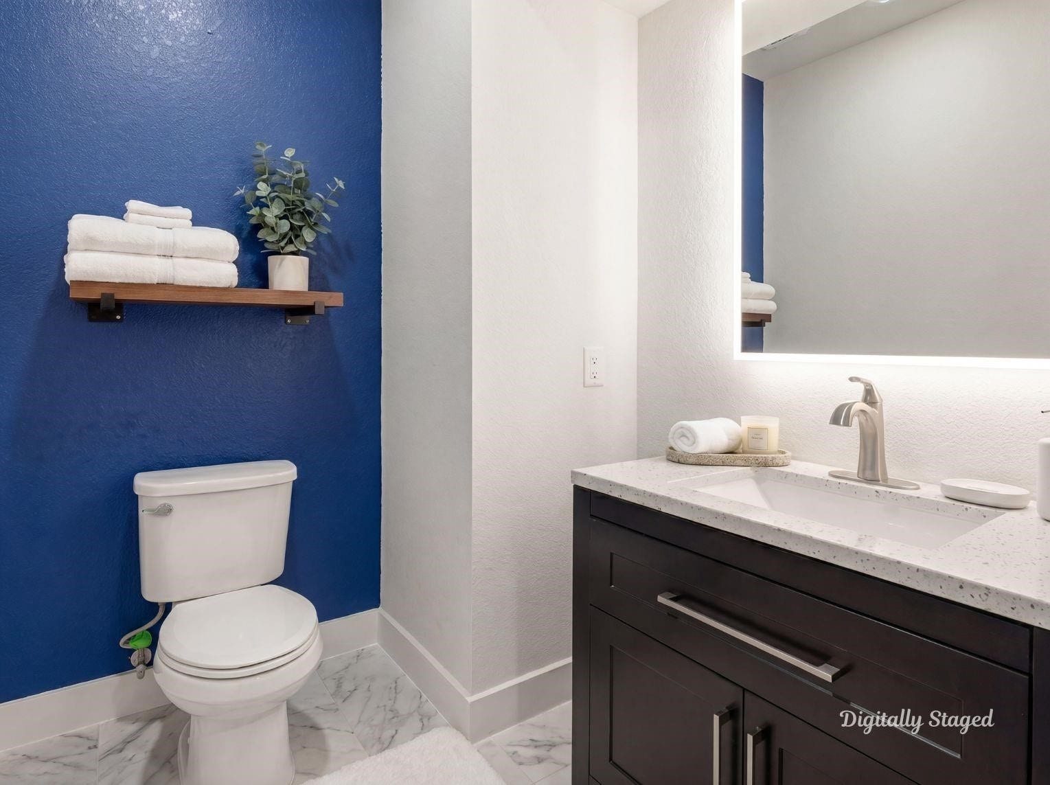 1715 Divino Pass, Conroe, TX 77304 A stylish half-bath or secondary
bathroom featuring a bold blue
accent wall, a dark vanity with a
stone countertop, a modern backlit
mirror, and marble-look tile floors.
This photo has been digitally staged
to illustrate the possibilities of the
homes aesthetic and potential
design. Some furnishings and dcor
shown are for visual inspiration.