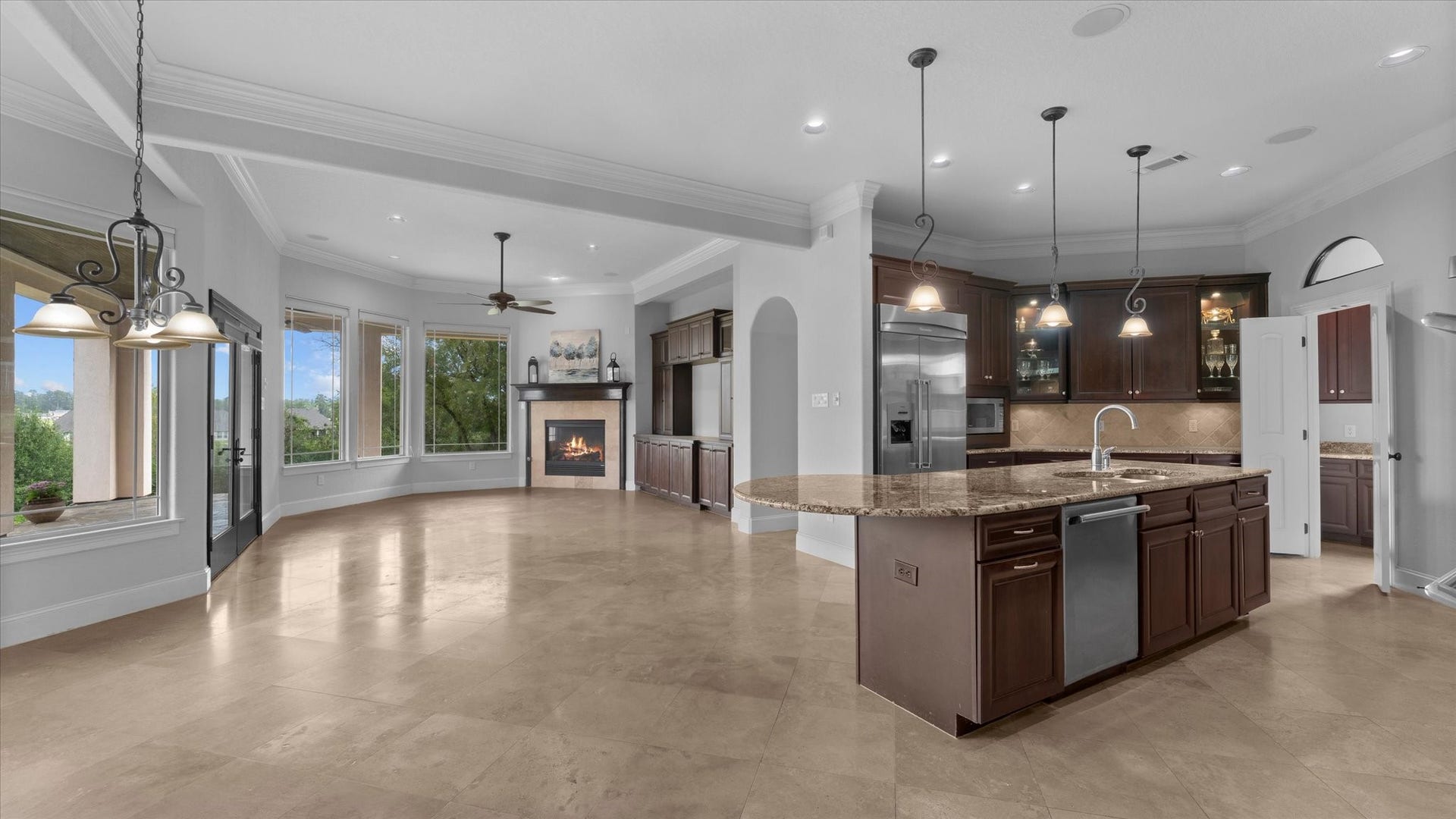 19182 Grandview Point, Montgomery, TX 77356 Breakfast area is to the right. Attached to the kitchen is a family room with a gas fireplace. Also attached is a guest room with an ensuite bathroom.