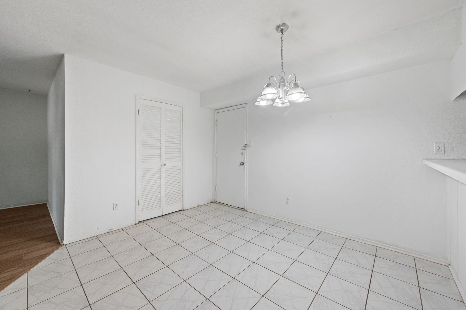 4649 Wild Indigo Street, #337, Houston, TX 77027 Bright dining area with tiled flooring, a modern light fixture, and ample natural light, perfect for intimate gatherings.