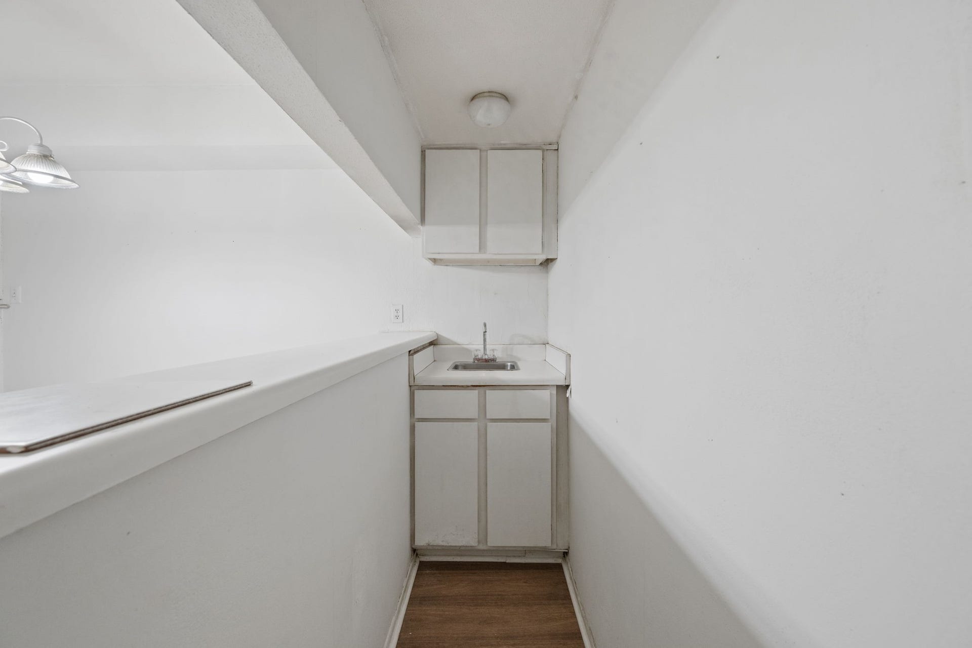 4649 Wild Indigo Street, #337, Houston, TX 77027 Cozy kitchenette with a compact sink, overhead cabinet storage, and a sleek countertop, perfect for efficient meal prep.