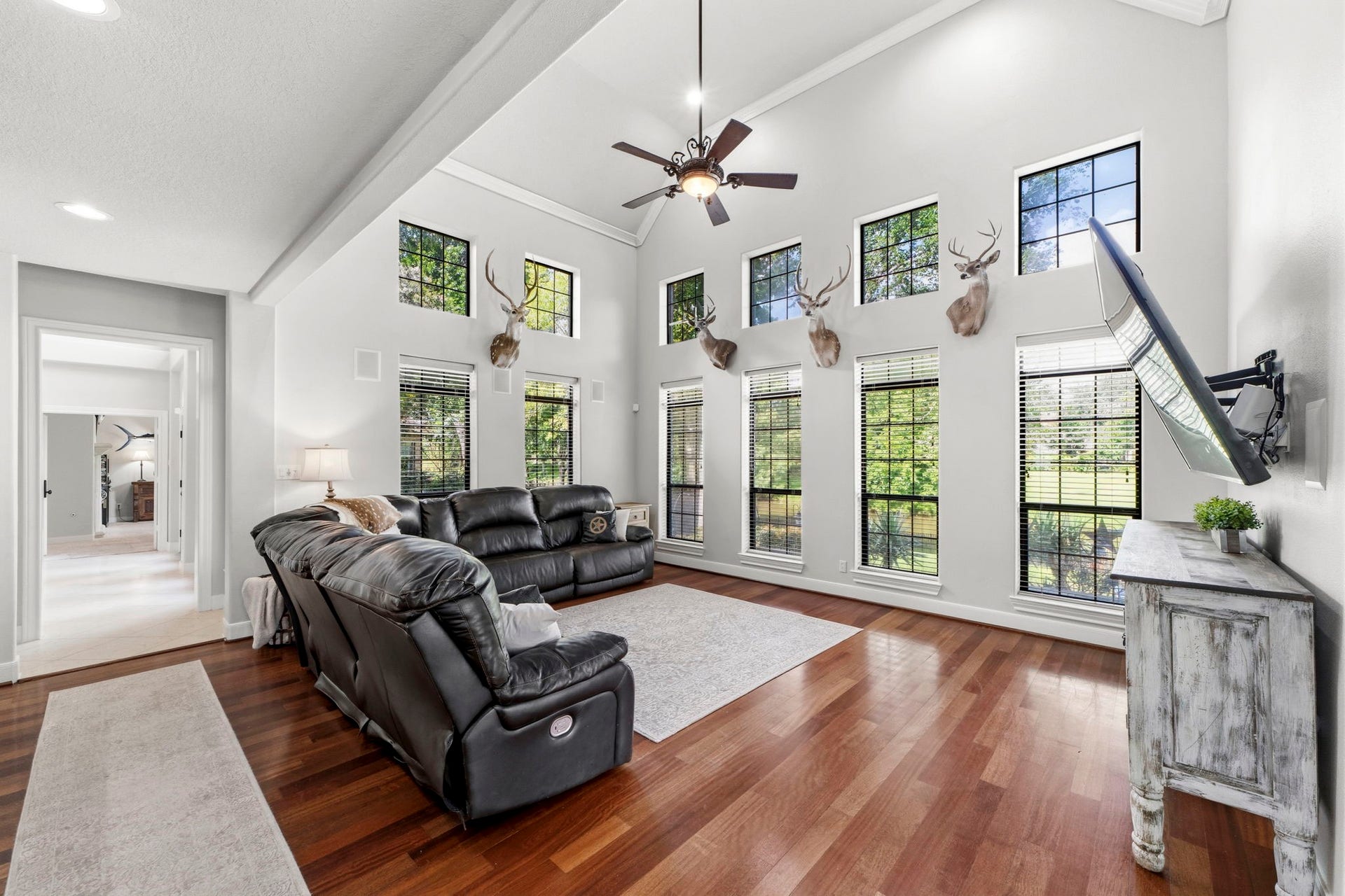 4903 Westerdale Drive, Fulshear, TX 77441 A dramatic wall of windows fills the family room with natural light while framing peaceful views of the backyard and waterfront beyond.