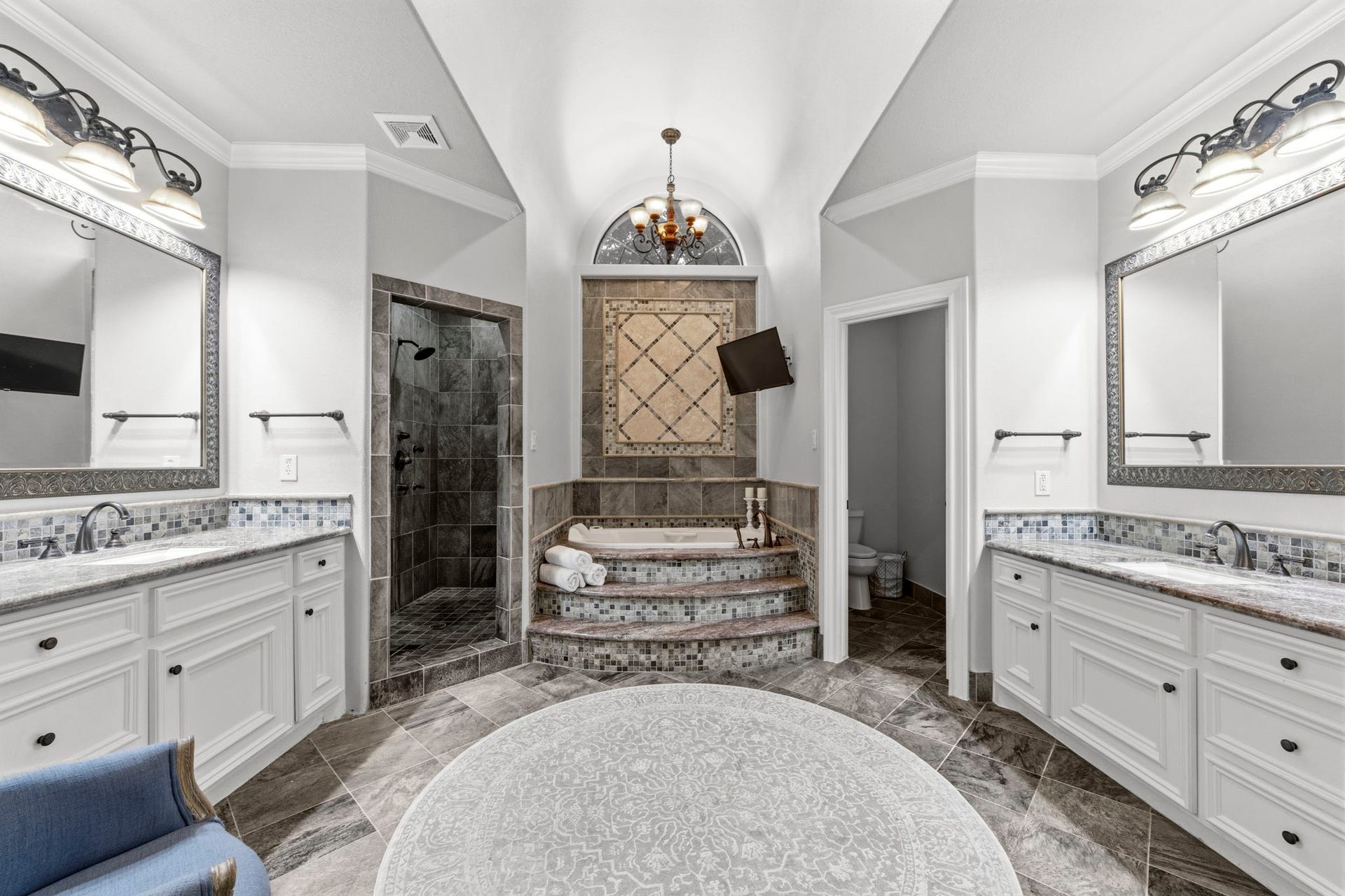 4903 Westerdale Drive, Fulshear, TX 77441 The spa-inspired primary bath features dual vanities, a jetted soaking tub, oversized walk-in shower, private water closet, and separate walk-in closets.