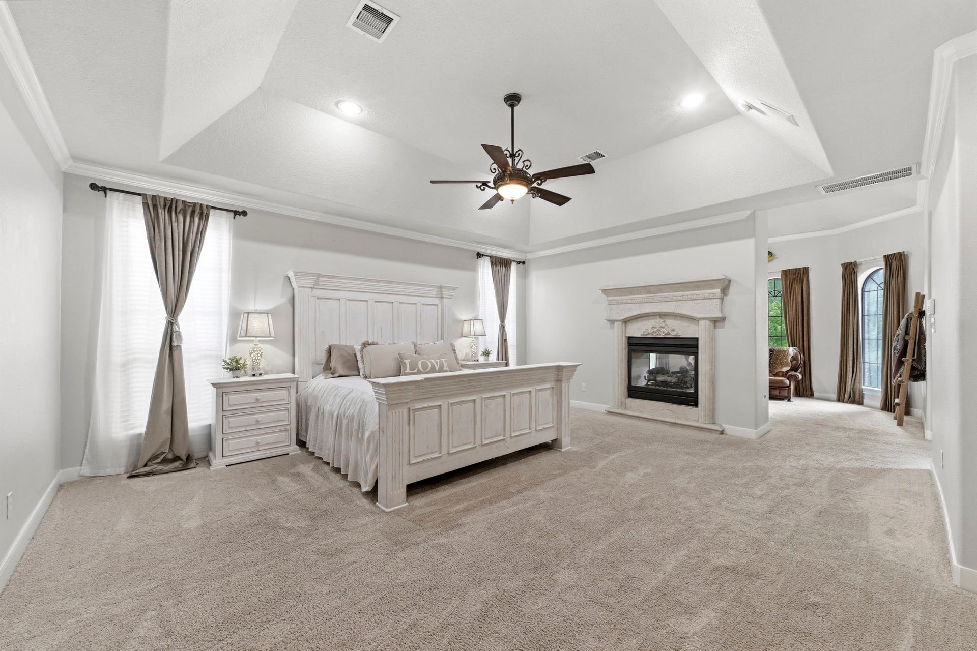 4903 Westerdale Drive, Fulshear, TX 77441 The spacious primary suite is separated from the adjoining retreat by a beautiful two-sided gas fireplace, creating distinct spaces while maintaining an open, luxurious feel.