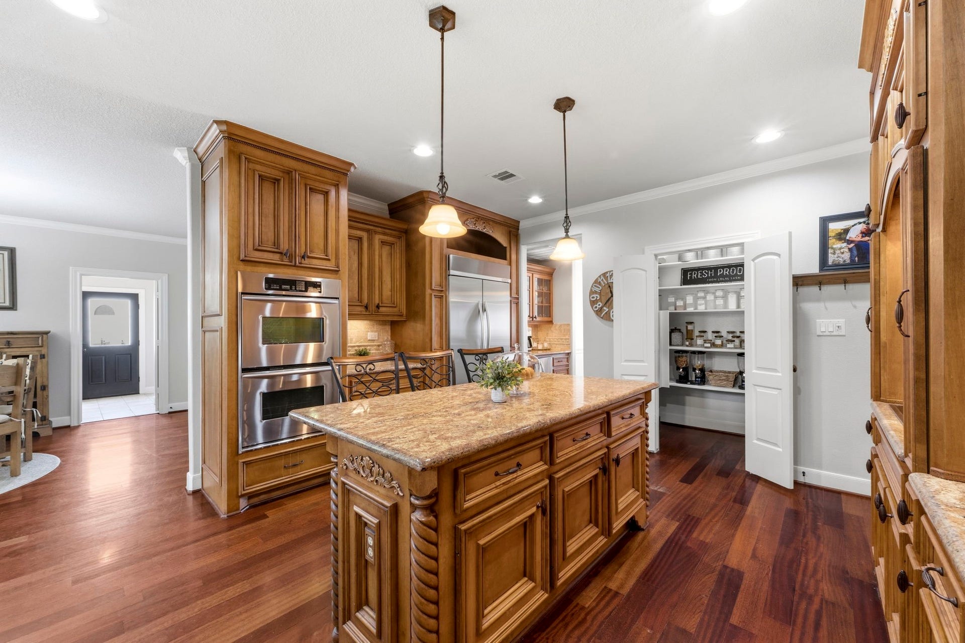 4903 Westerdale Drive, Fulshear, TX 77441 Designed for the home chef, the kitchen features double electric ovens (including a convection oven on top) a built-in refrigerator, and a spacious walk-in pantry for great storage.
