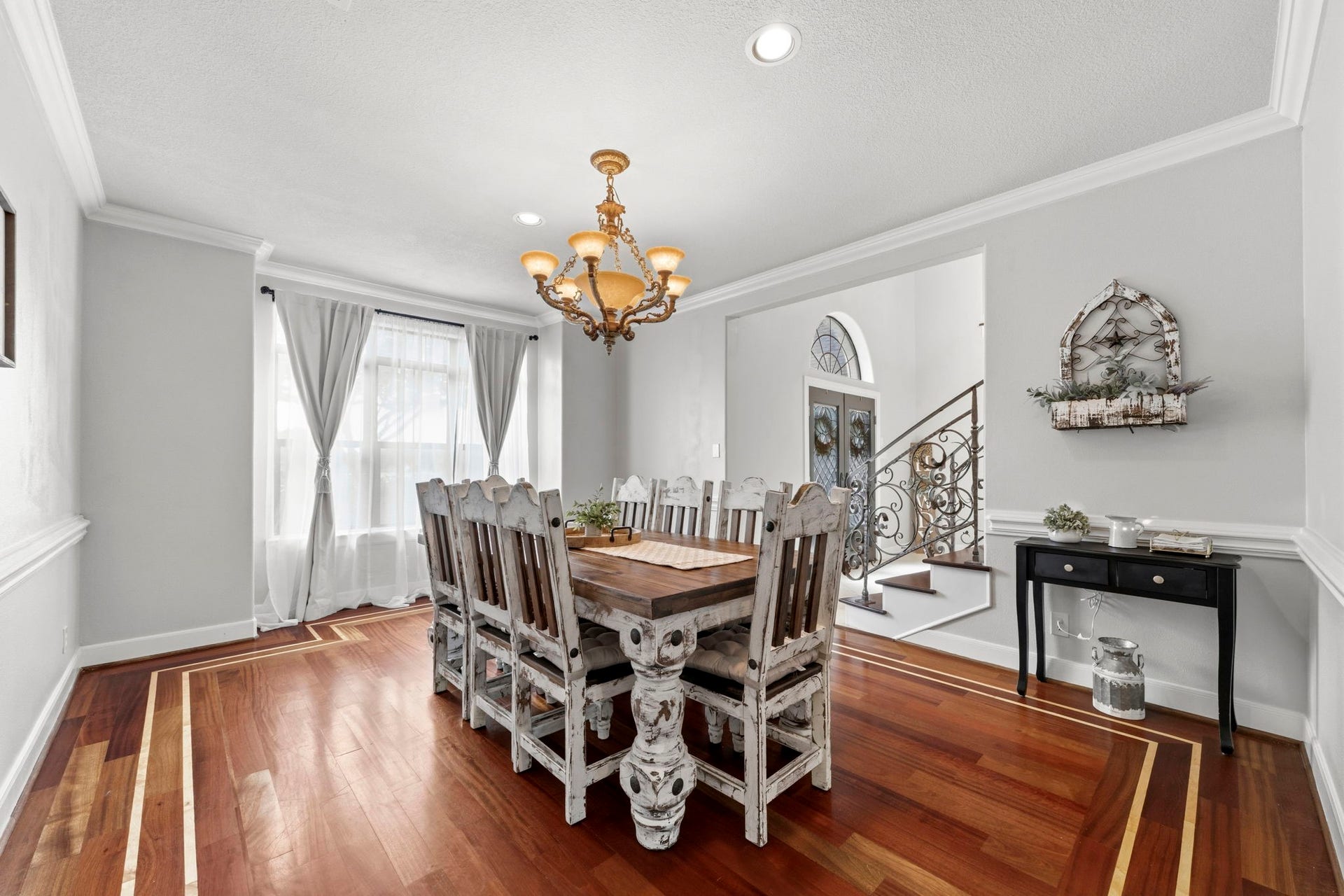 4903 Westerdale Drive, Fulshear, TX 77441 Generously sized 17' x 13' formal dining room features rich hardwood flooring, crown molding, and large front windows that fill the space with natural light.