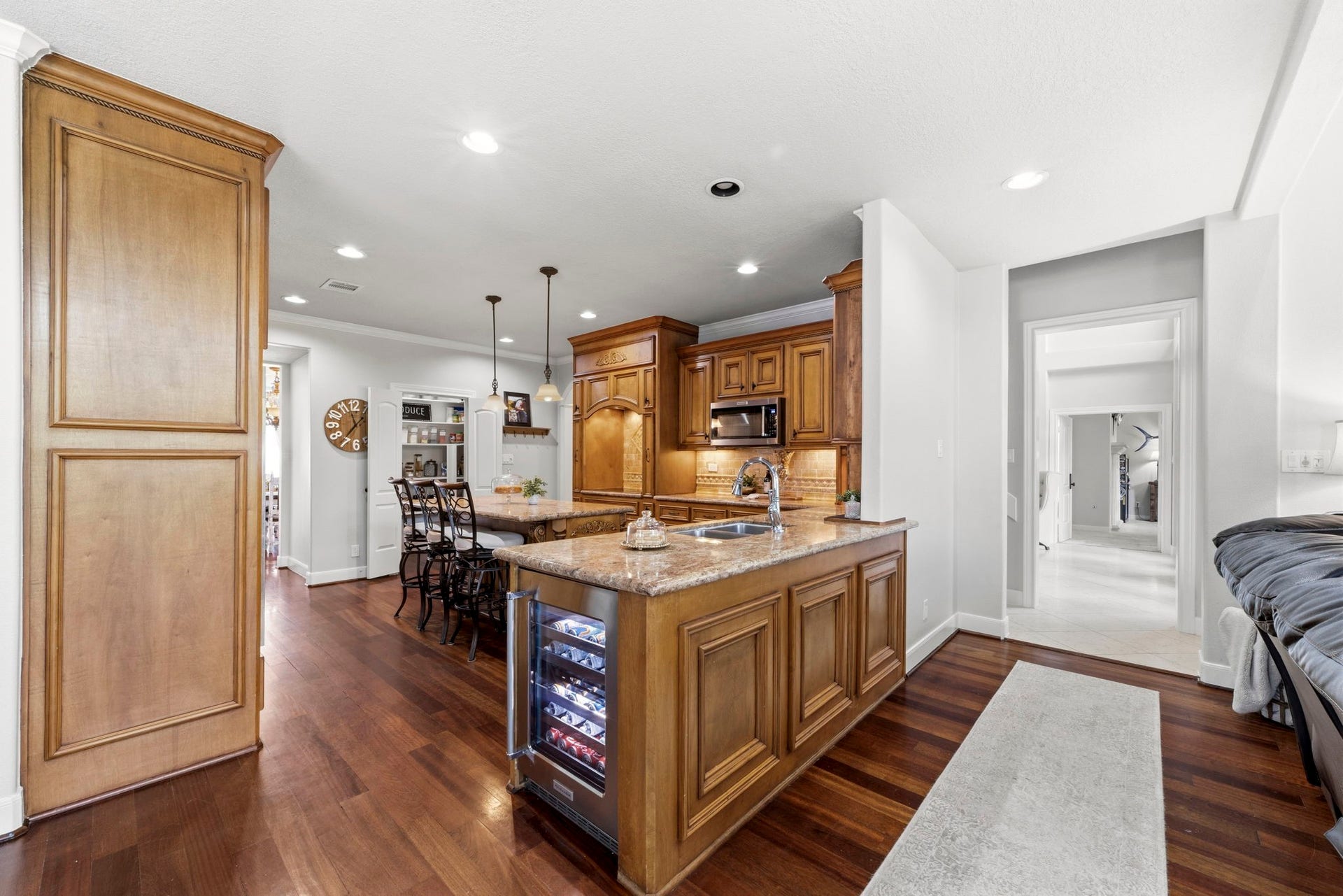 4903 Westerdale Drive, Fulshear, TX 77441 The heart of the home is a timeless island kitchen featuring furniture-quality custom cabinetry, granite countertops, rich wood flooring, and an open layout designed for both everyday living and entertaining.