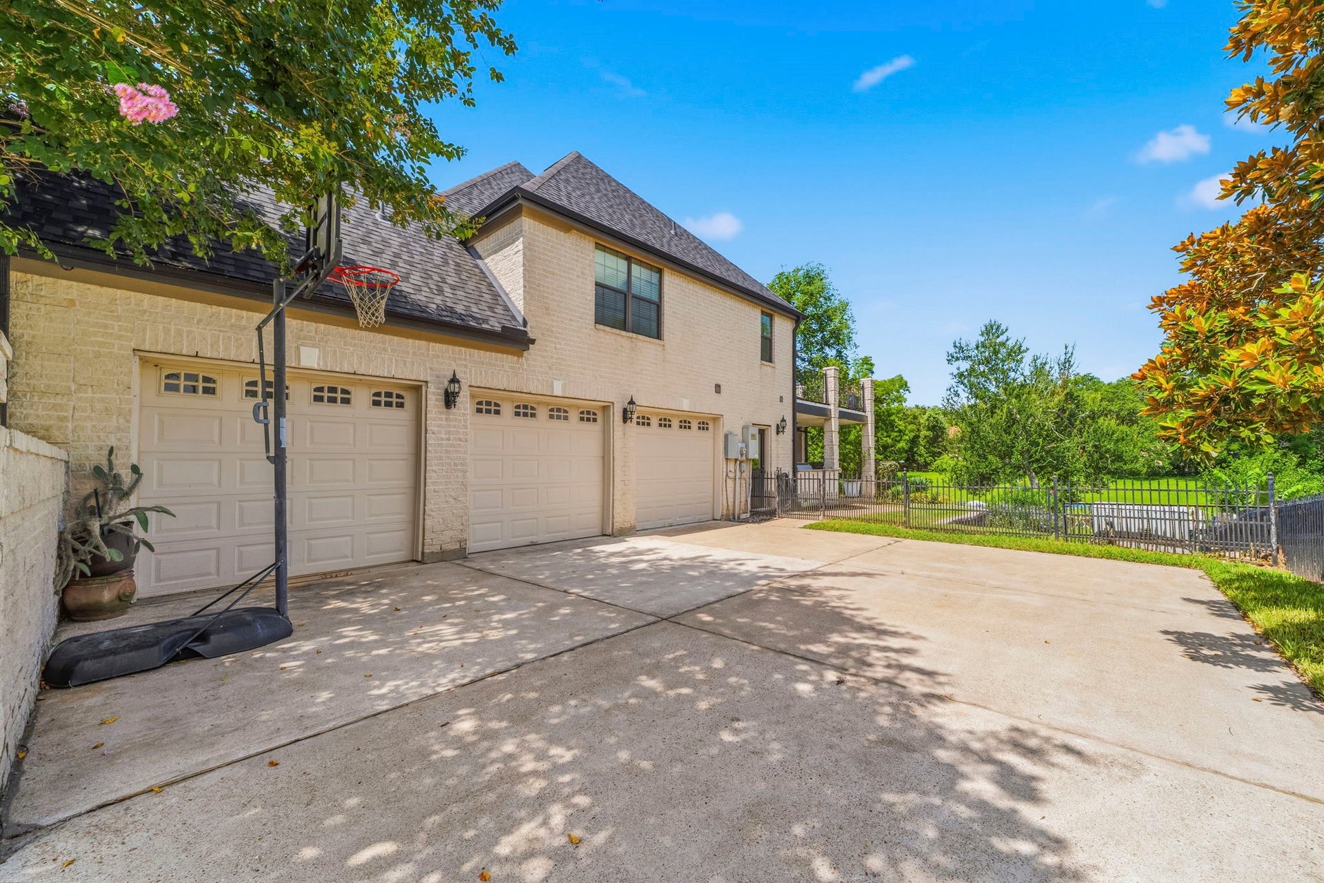 4903 Westerdale Drive, Fulshear, TX 77441 Private gated driveway leads to the oversized 3-car garage with ample space for vehicles, golf carts, and storage.