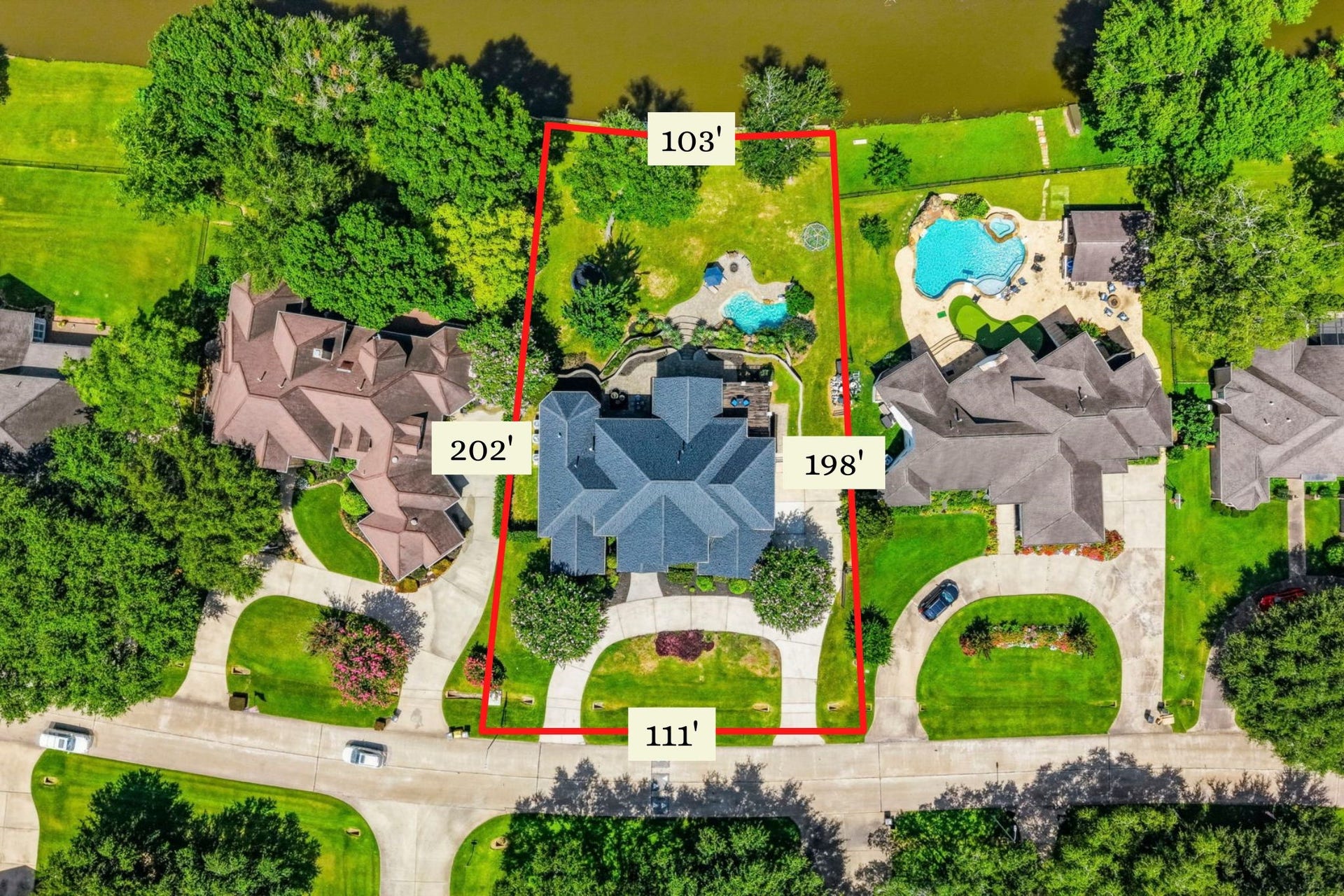 4903 Westerdale Drive, Fulshear, TX 77441 111 foot frontage with 103 feet across the back on the canal. Circular driveway.