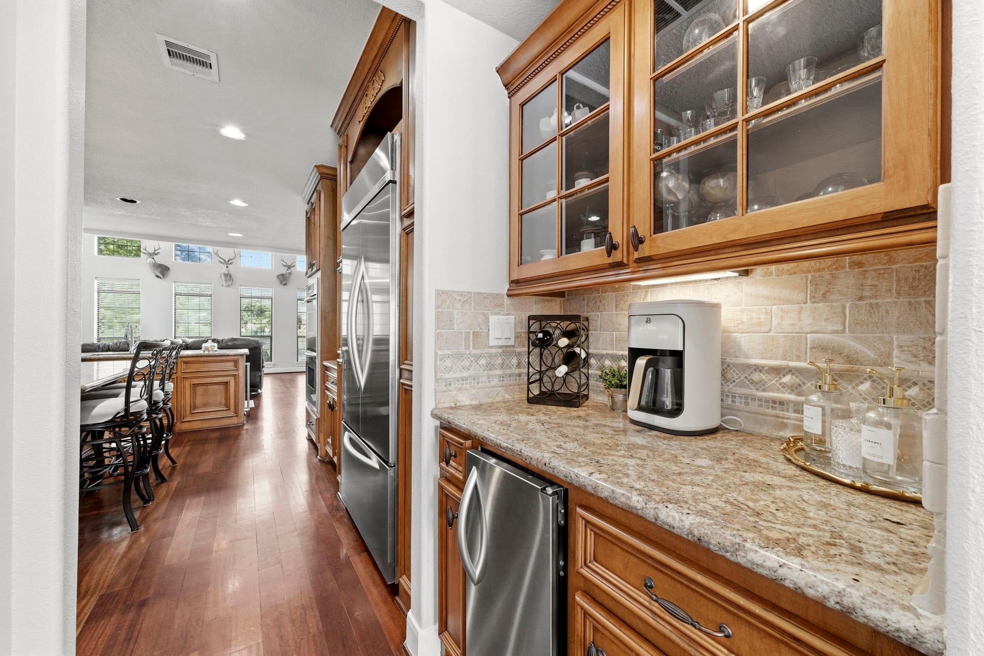 4903 Westerdale Drive, Fulshear, TX 77441 The butler's pantry extends the functionality of the kitchen with additional countertop space, upper display cabinets, and ample storage for serving and entertaining.
