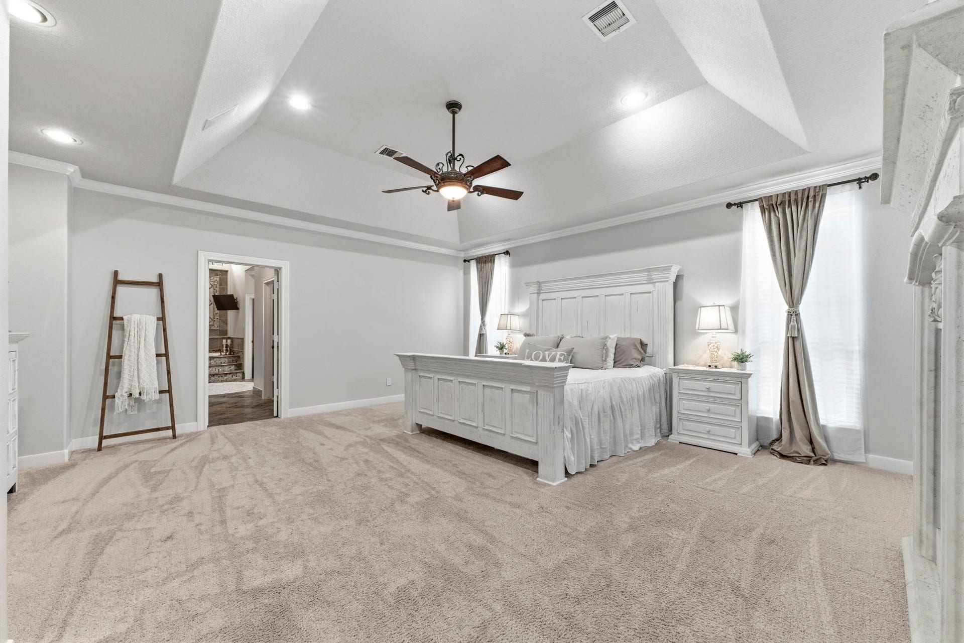 4903 Westerdale Drive, Fulshear, TX 77441 19' x 17' primary bedroom with tray ceiling, abundant natural light, and generous space for a king-sized bedroom suite.