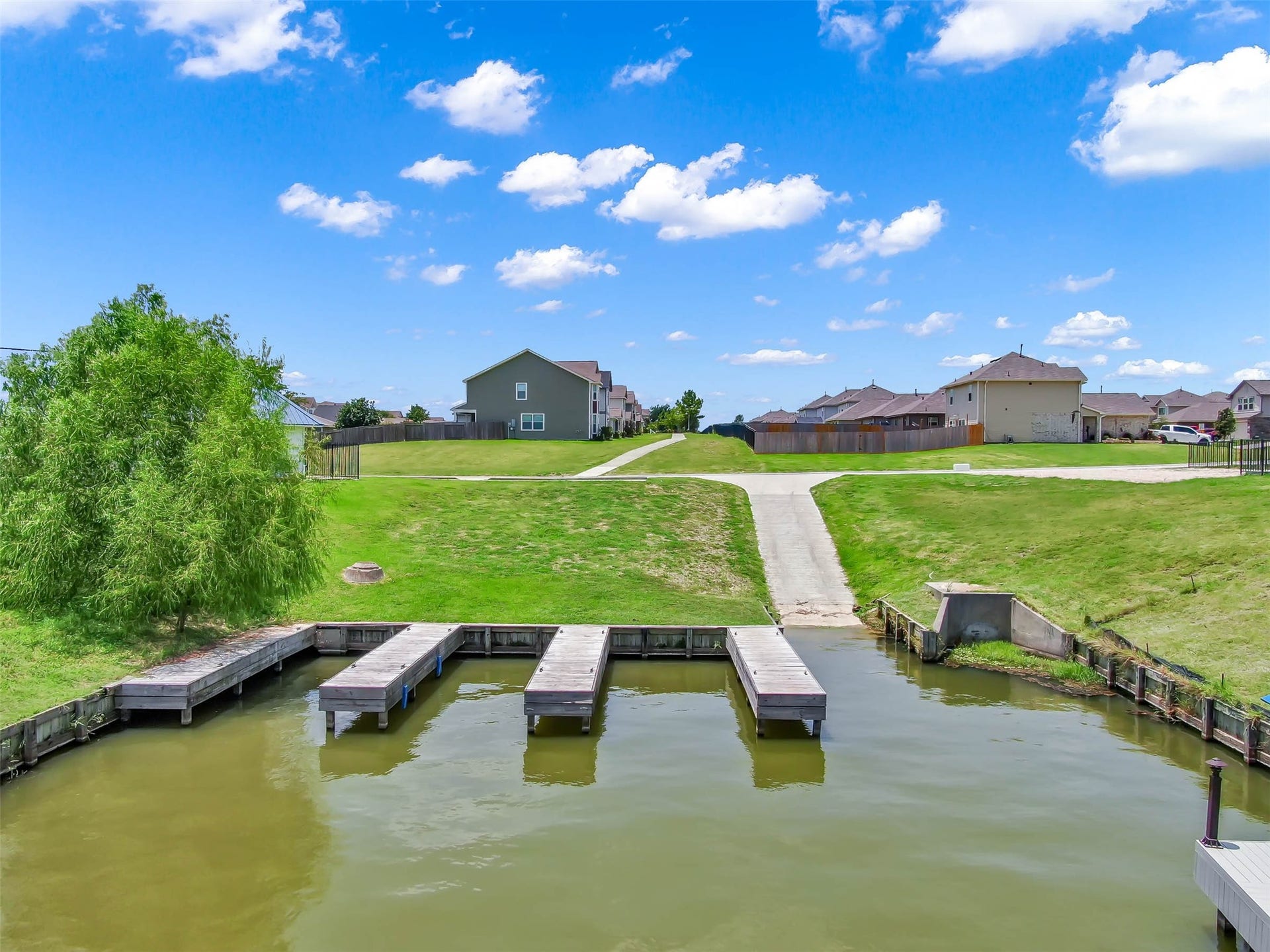 Community boat docks and boat ramp providing convenient access to Lake Conroe for boating and fishing.