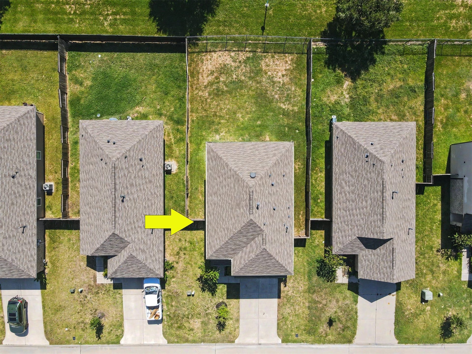 Overhead aerial view highlighting the home's spacious, fully fenced backyard and surrounding neighborhood.