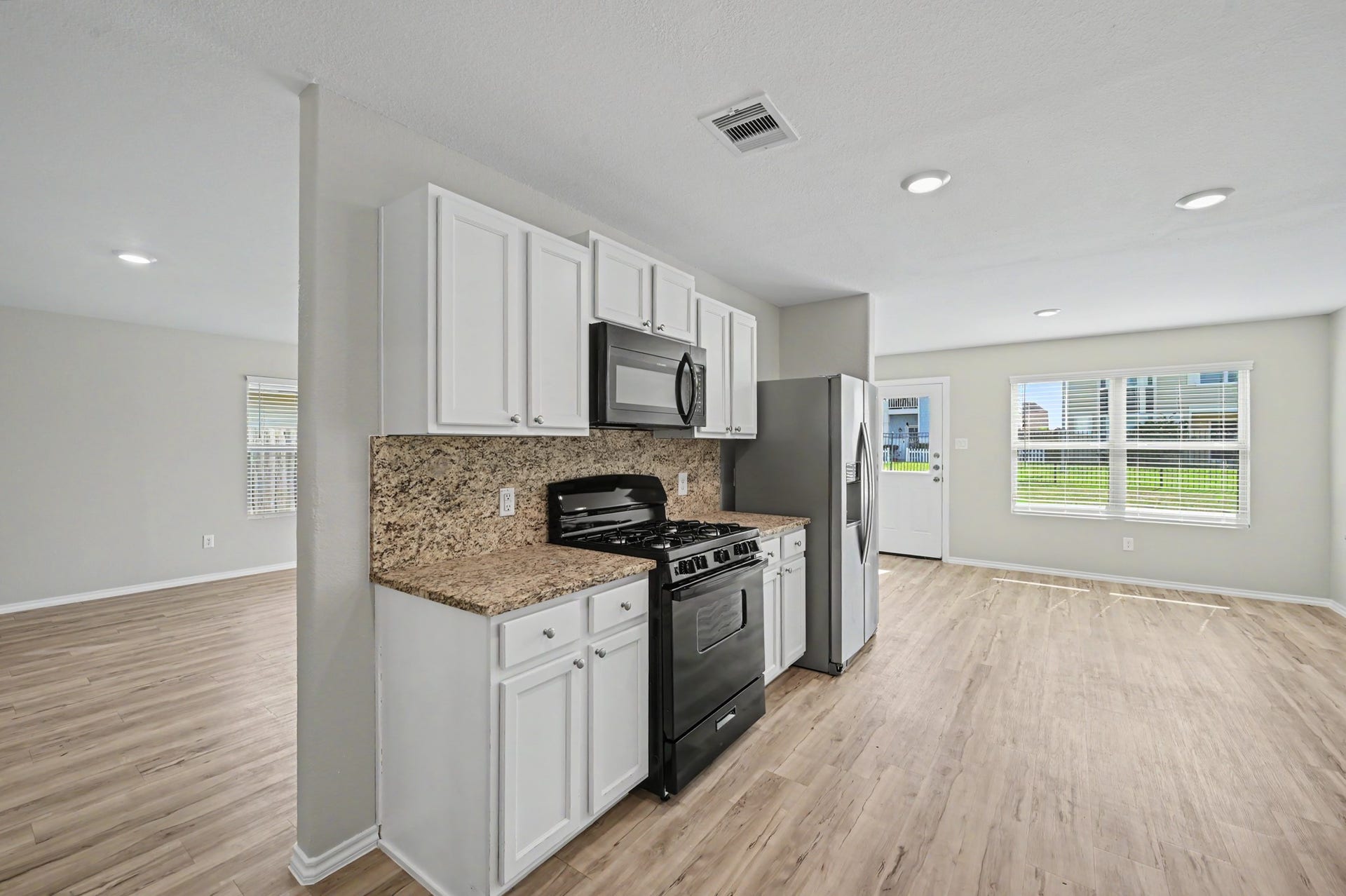 Kitchen opens to the spacious dining and living areas.