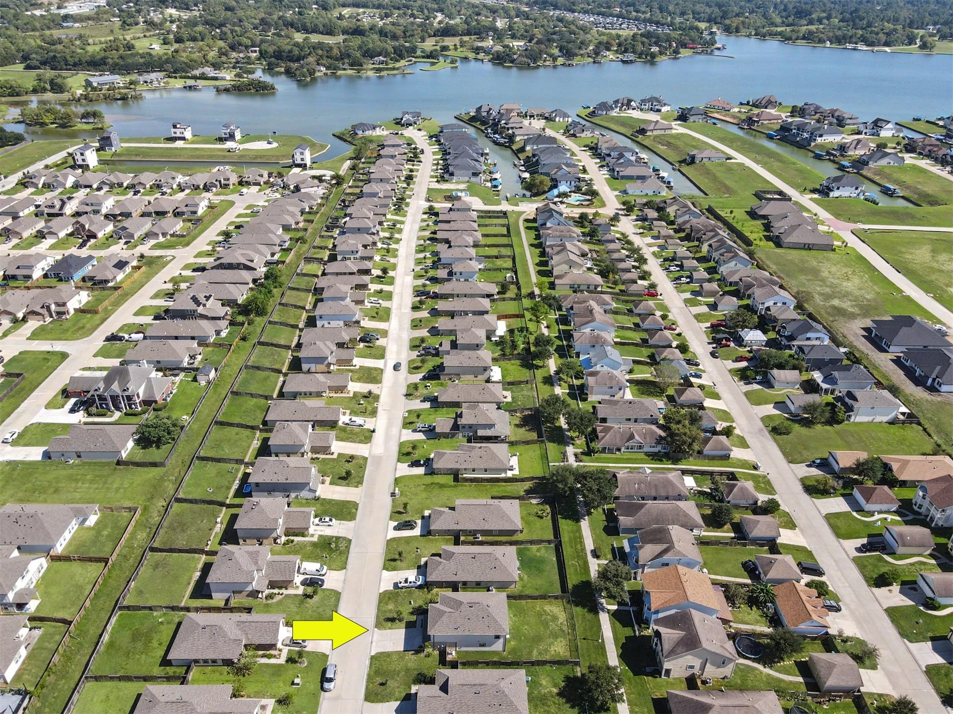 Aerial view showcasing the home's neighborhood location and proximity to the lake.