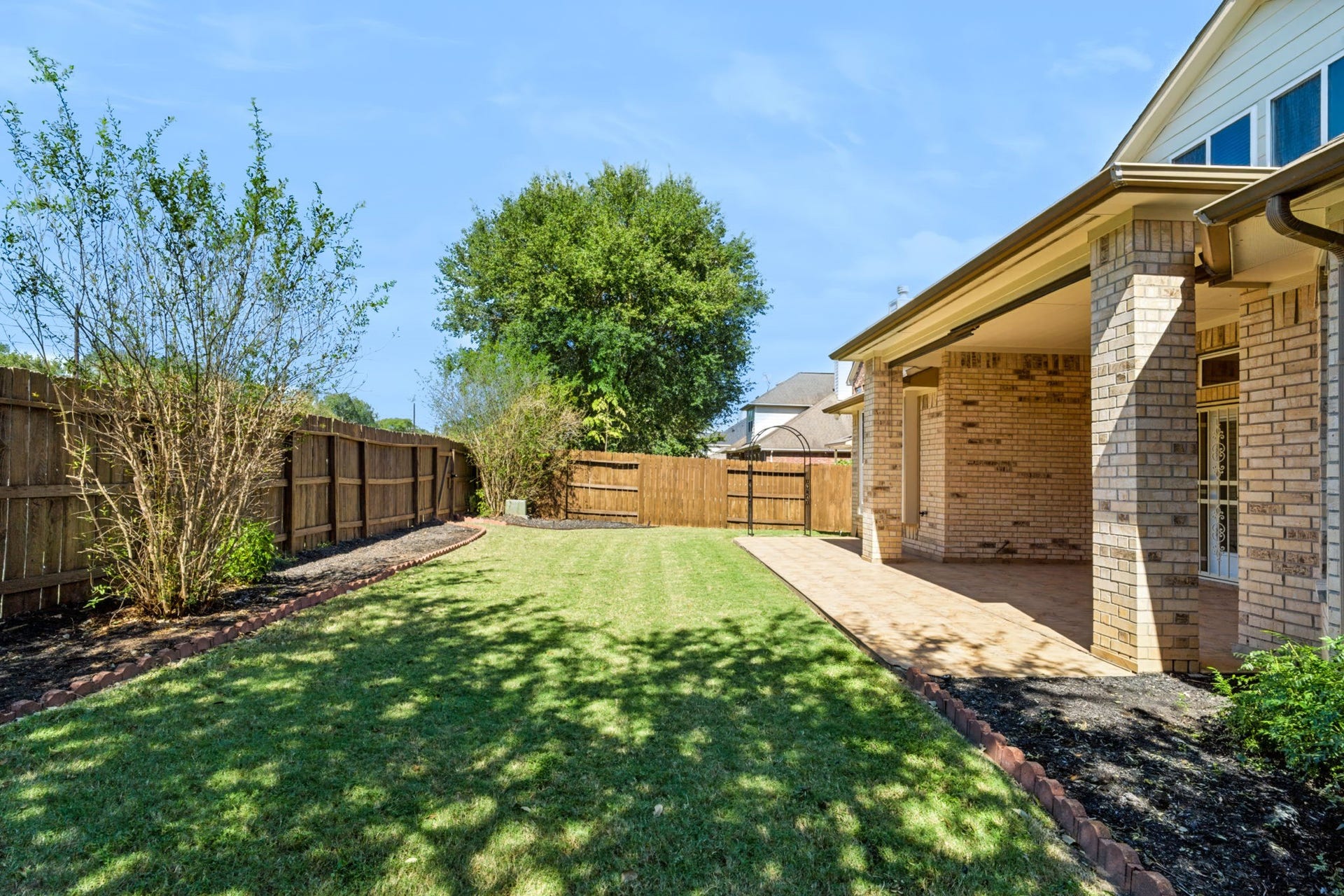 314 Trillium Drive, Sugar Land, TX 77479 Fenced backyard with grassy lawnperfect for children and outdoor activities.
