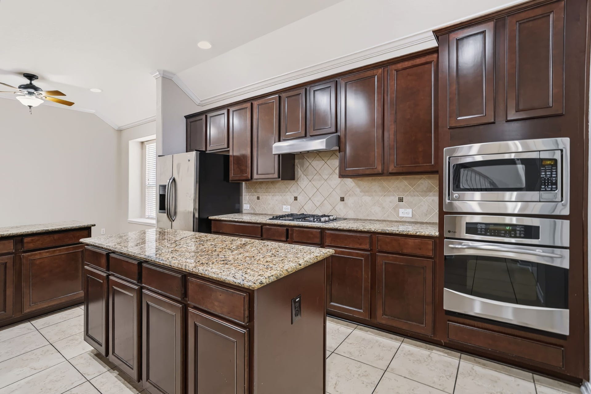 314 Trillium Drive, Sugar Land, TX 77479 The kitchen features a built-in stainless steel gas cooktop, convection oven, and microwave.