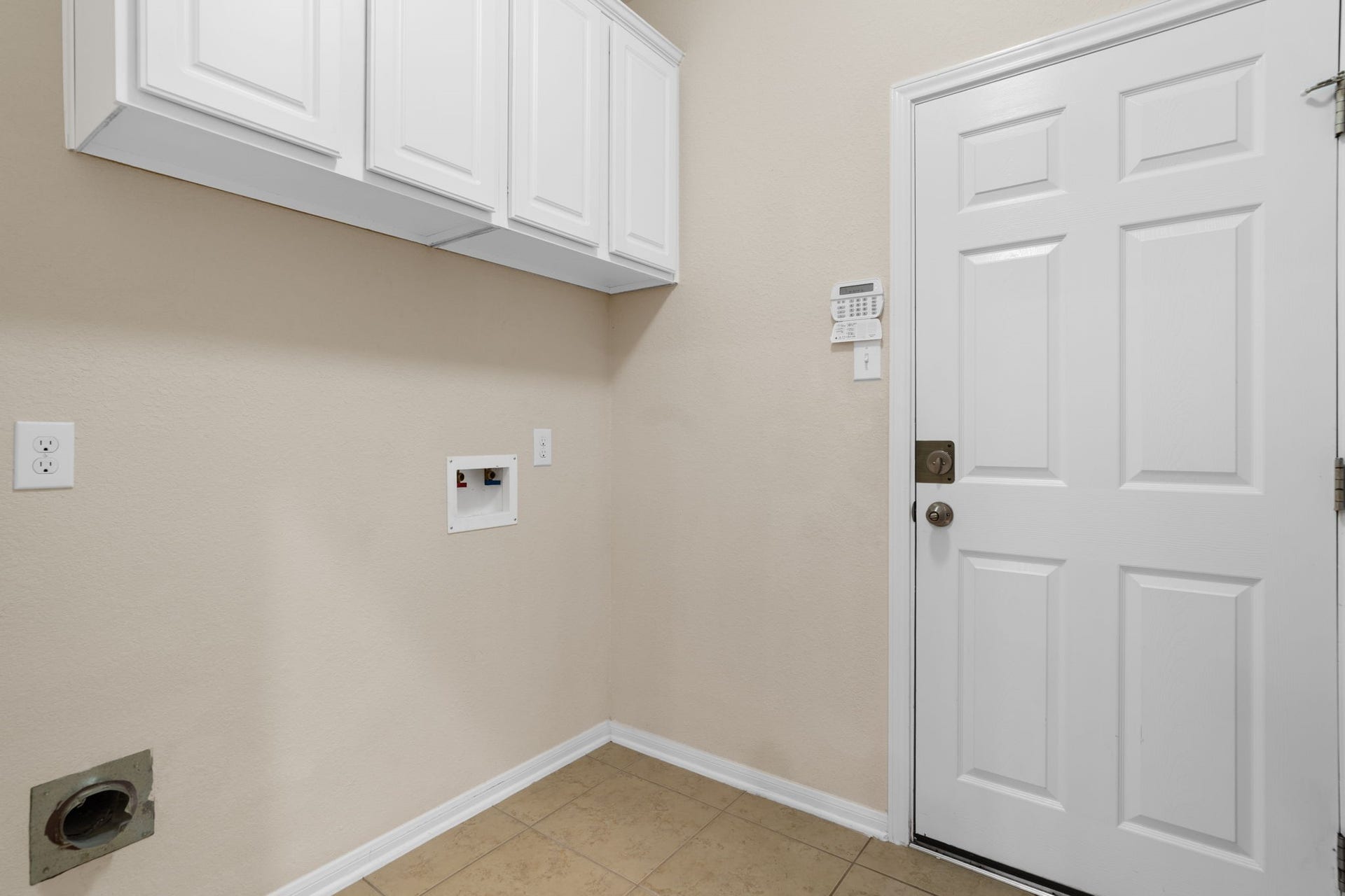 314 Trillium Drive, Sugar Land, TX 77479 First floor in-home laundry room with built-in storage cabinets and direct access to the attached garage.