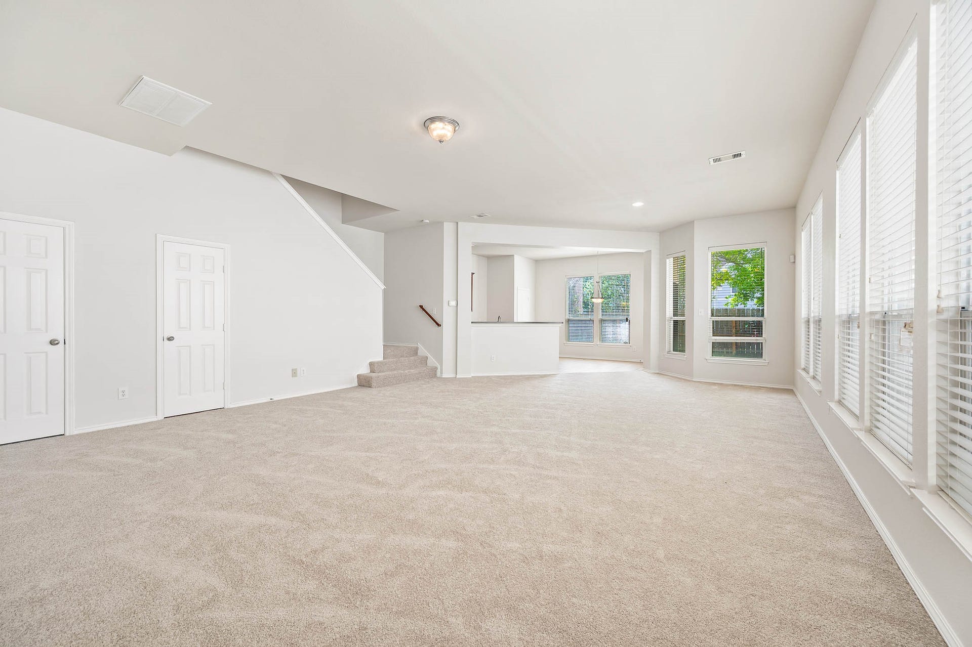 14923 ATMORE Place Dr, Houston, TX 77082 Living area. new carpet, fresh designer paint, large windows providing ample natural light, and an open layout leading to a cozy dining nook. Perfect for family gatherings and entertaining.