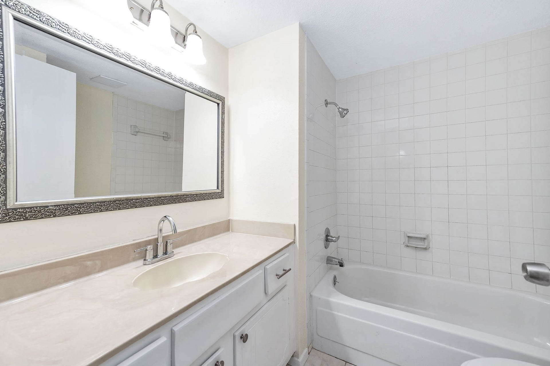 14923 ATMORE Place Dr, Houston, TX 77082 Bathroom features a clean design, large mirror and designer lighting, spacious vanity. Bathtub with tiled walls Combination shower.