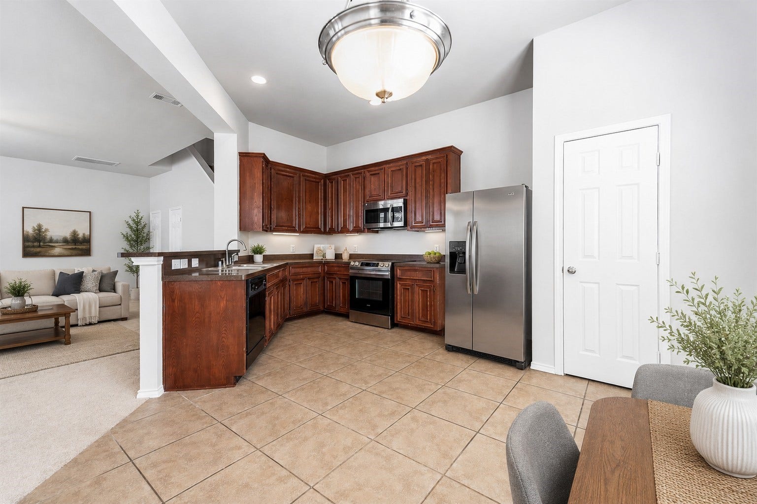 14923 ATMORE Place Dr, Houston, TX 77082 Enter the spacious kitchen/dining areas and note rich wooden cabinets, stainless steel appliances, and a designer tile flooring. This area allows an open floor plan that includes a spacious adjacent living/family room Note Illuminating designer ceiling light fixtures! Virtually staged to inspire design possibilities