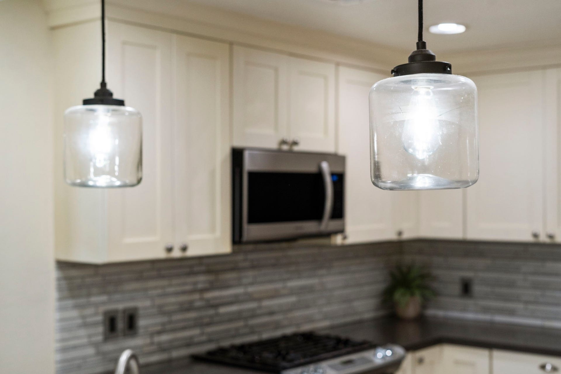 2915 Cane Field Drive, Sugar Land, TX 77479 Glass pendant lighting adds a modern touch above the breakfast bar.