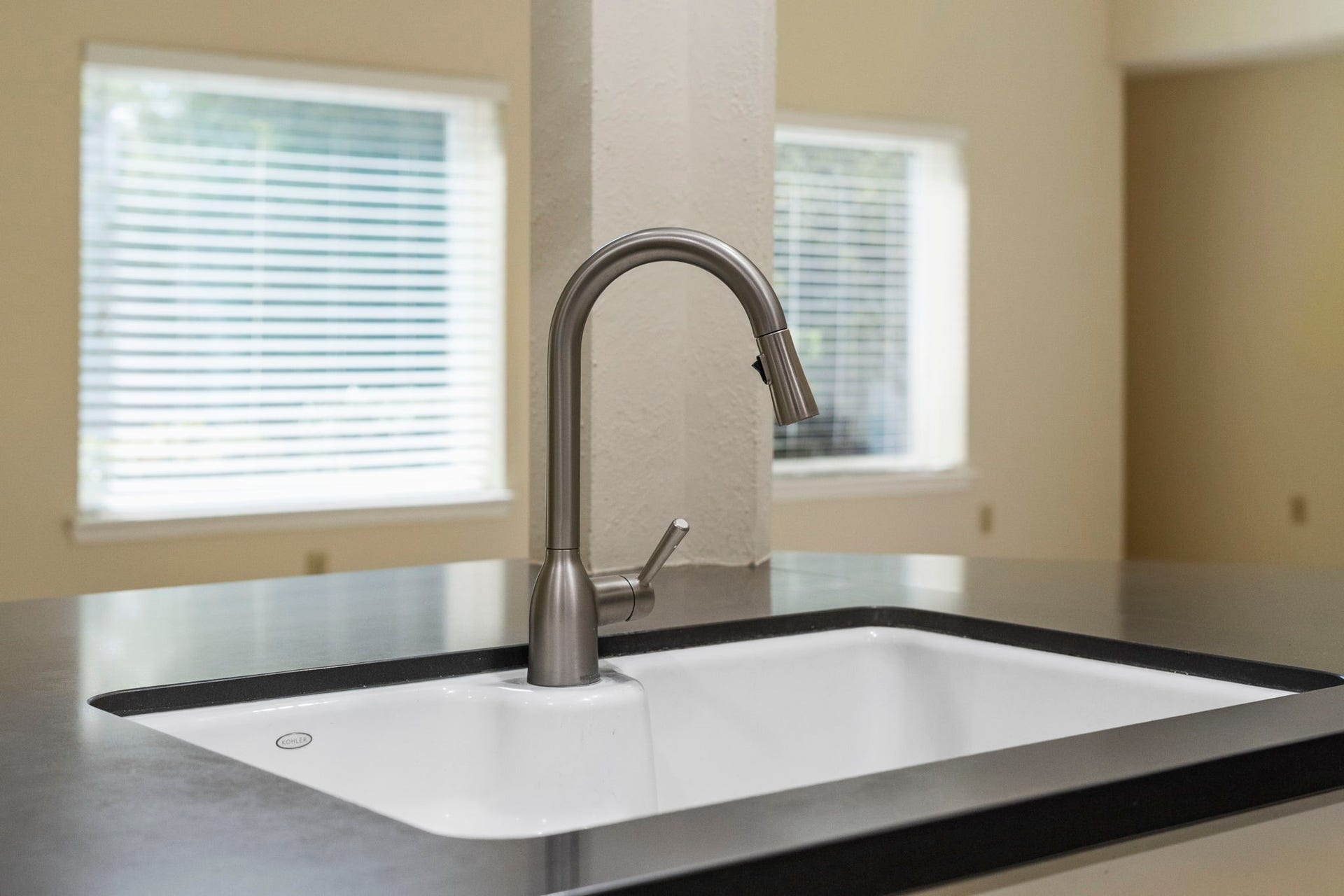 2915 Cane Field Drive, Sugar Land, TX 77479 A sleek pull-down faucet & undermount sink offer a clean, modern finish at the kitchens breakfast bar.