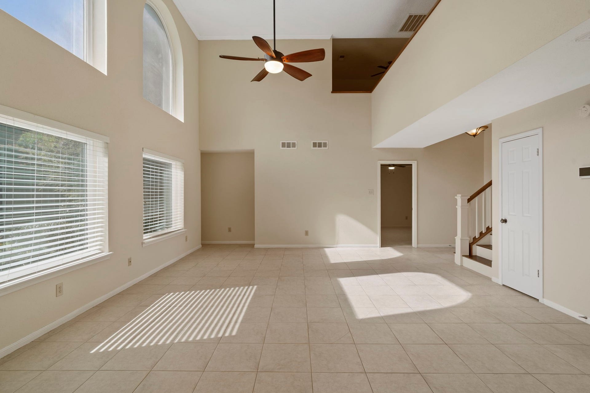2915 Cane Field Drive, Sugar Land, TX 77479 Dramatic two-story windows fill the family room with natural light.