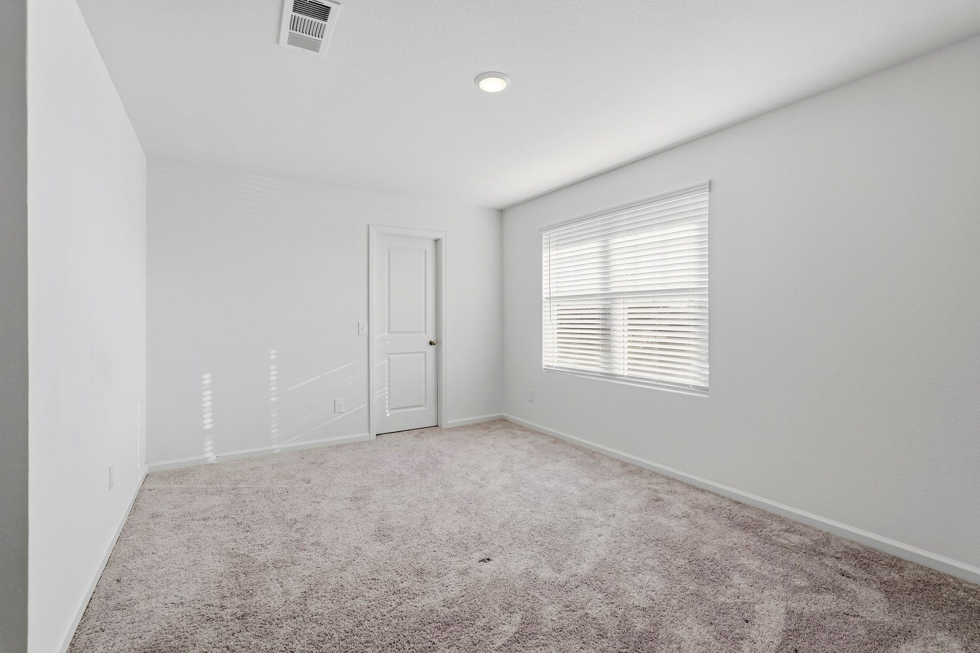 21547 Rolling Streams Drive, New Caney, TX 77357 This bright and inviting secondary bedroom features a comfortable, spacious layout with crisp white walls, plush neutral carpeting, and a clean, contemporary aesthetic.