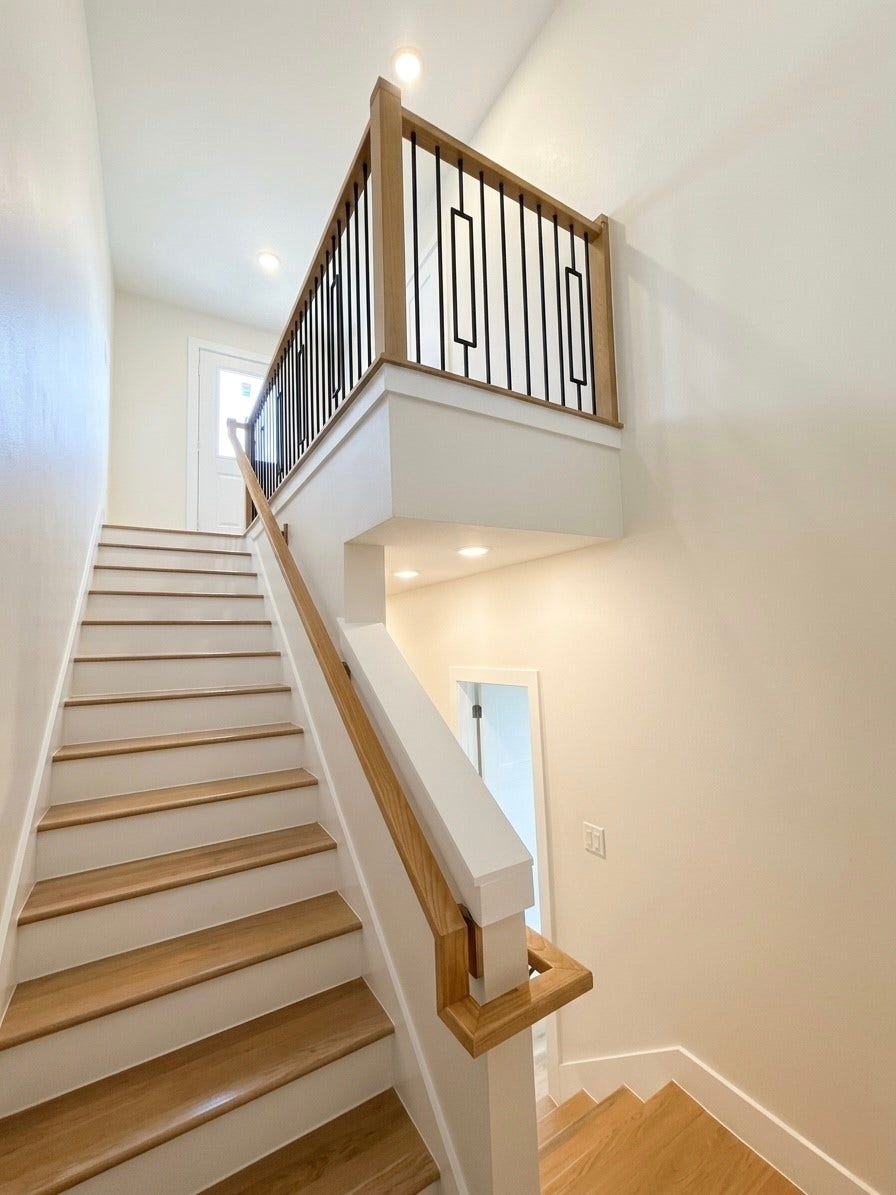 102 Sylvester Road, #C, Houston, TX 77009 Bright and modern staircase with sleek wood accents and elegant iron railings, leading to an inviting upper level.