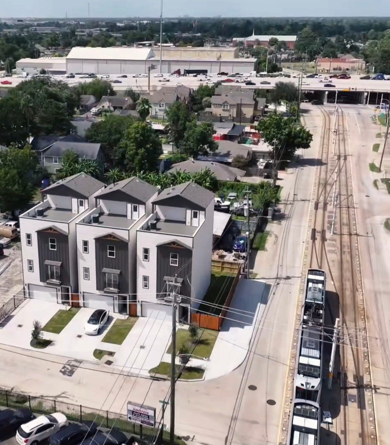 102 Sylvester Road, #C, Houston, TX 77009 Modern townhomes with sleek designs, each featuring a private driveway and small yard, conveniently located near a light rail line for easy commuting.