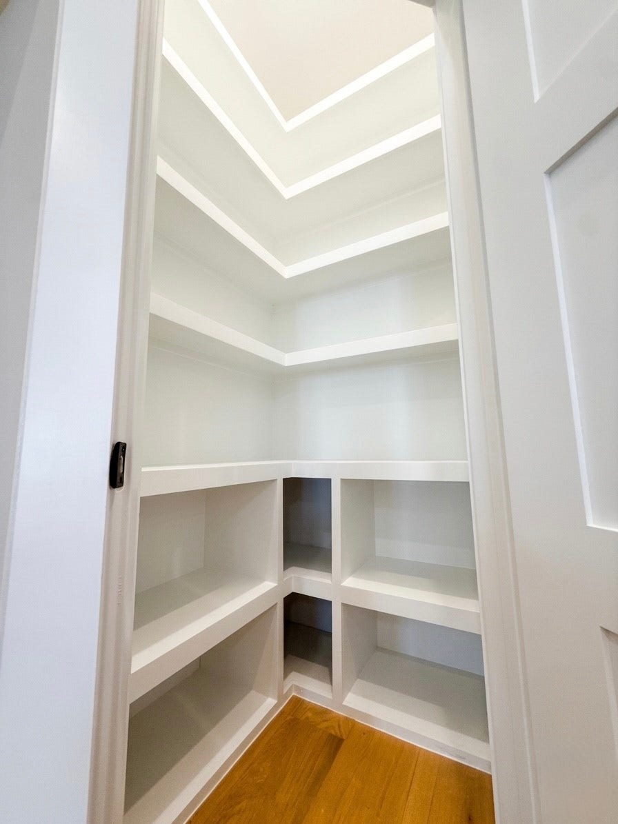 102 Sylvester Road, #C, Houston, TX 77009 Spacious walk-in pantry with custom-built shelving, perfect for organized storage.