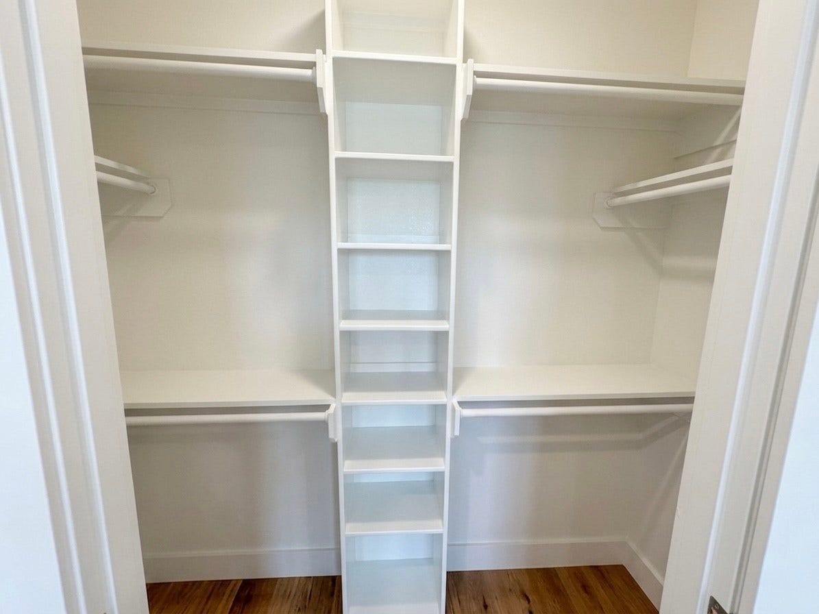 102 Sylvester Road, #C, Houston, TX 77009 Spacious walk-in closet featuring ample shelving and dual hanging rods for organized storage.