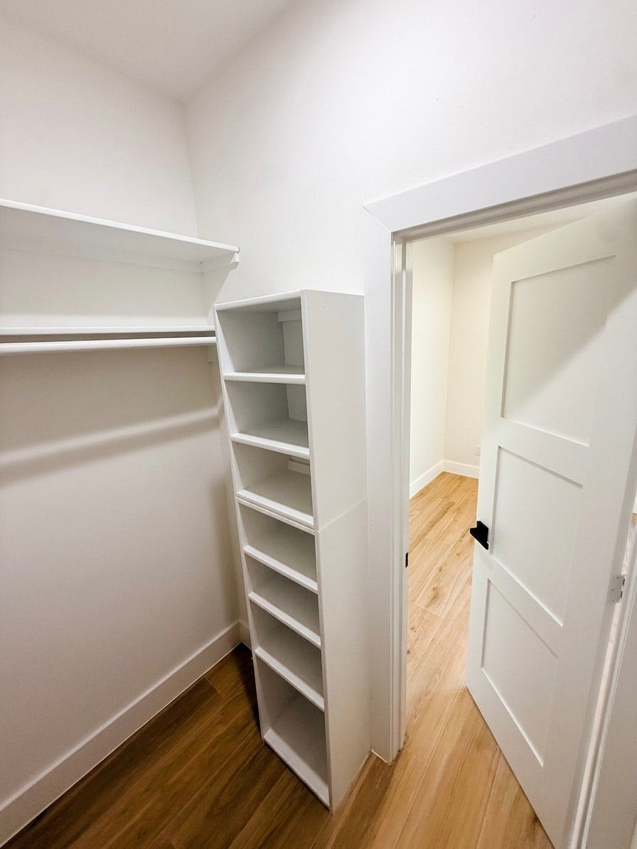102 Sylvester Road, #C, Houston, TX 77009 Spacious walk-in closet with built-in shelving and hanging space, featuring elegant.