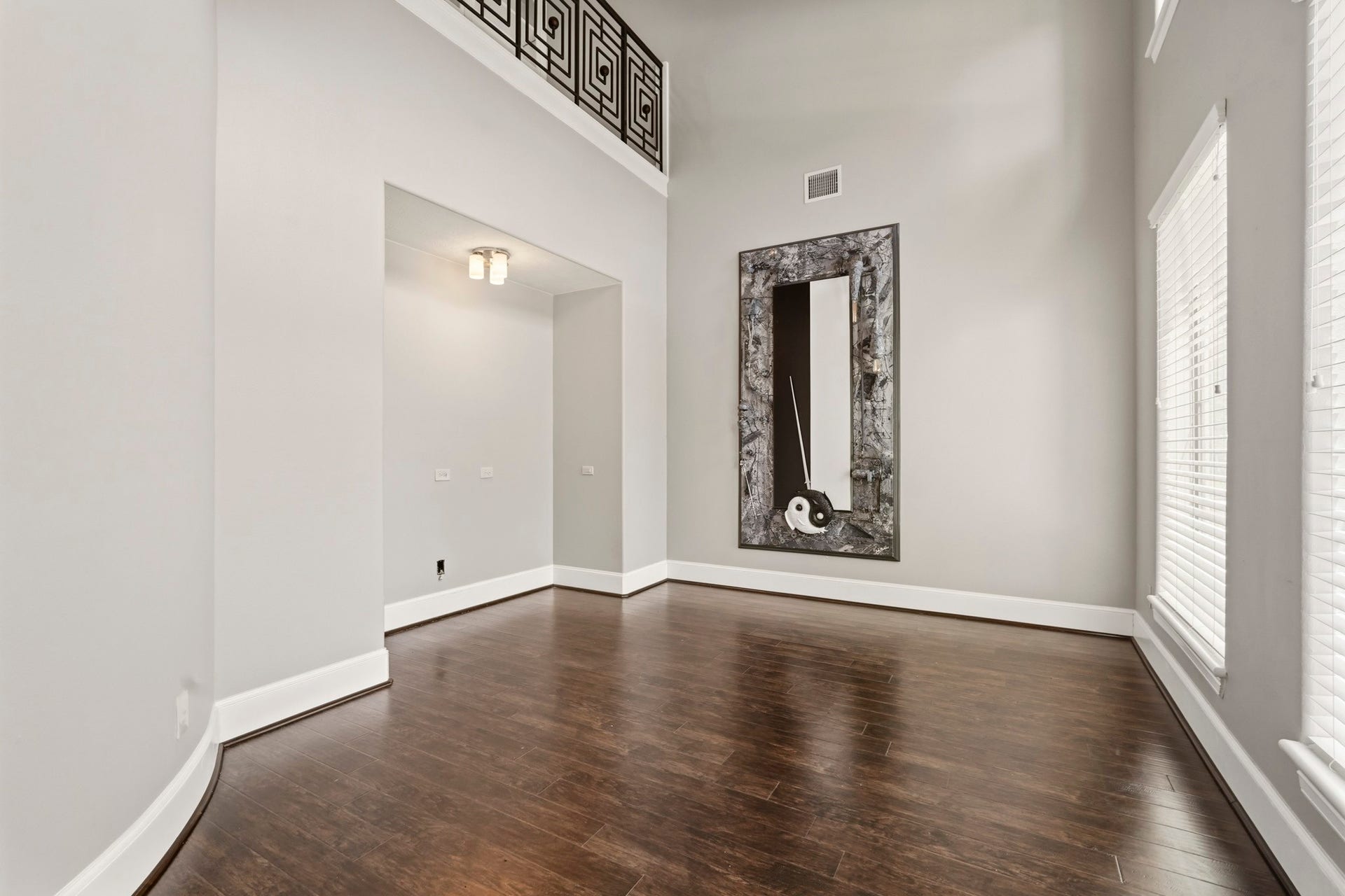 7611 Kings River Lane, Humble, TX 77346 Second-story study/library featuring rich wood flooring, custom built-in shelving and cabinetry, crown molding, and abundant natural lightan ideal space for a private home office or reading retreat.