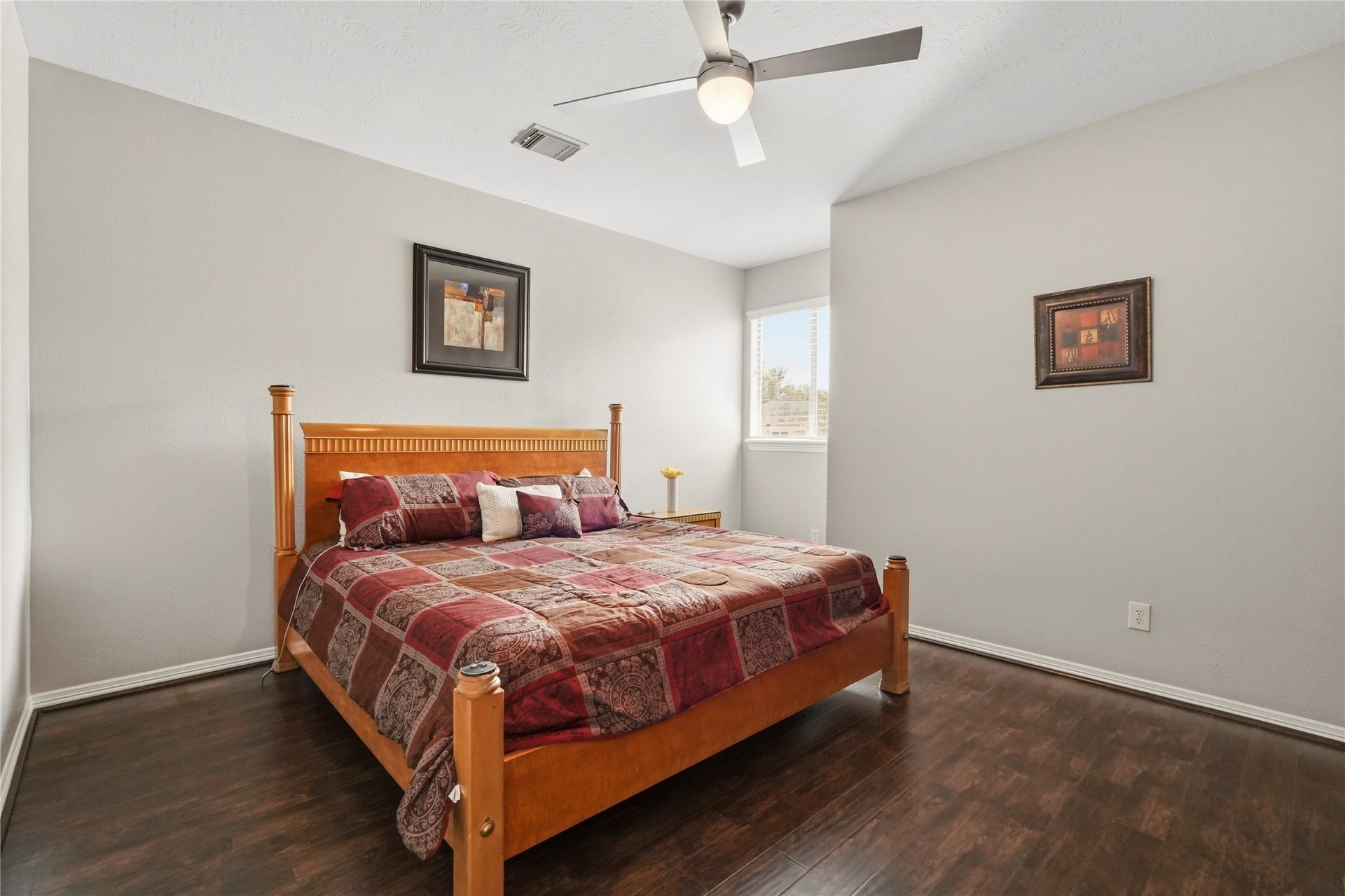 7611 Kings River Lane, Humble, TX 77346 Generously sized secondary bedroom features rich wood flooring, crown molding, ceiling fan and ample space for a complete bedroom suite.