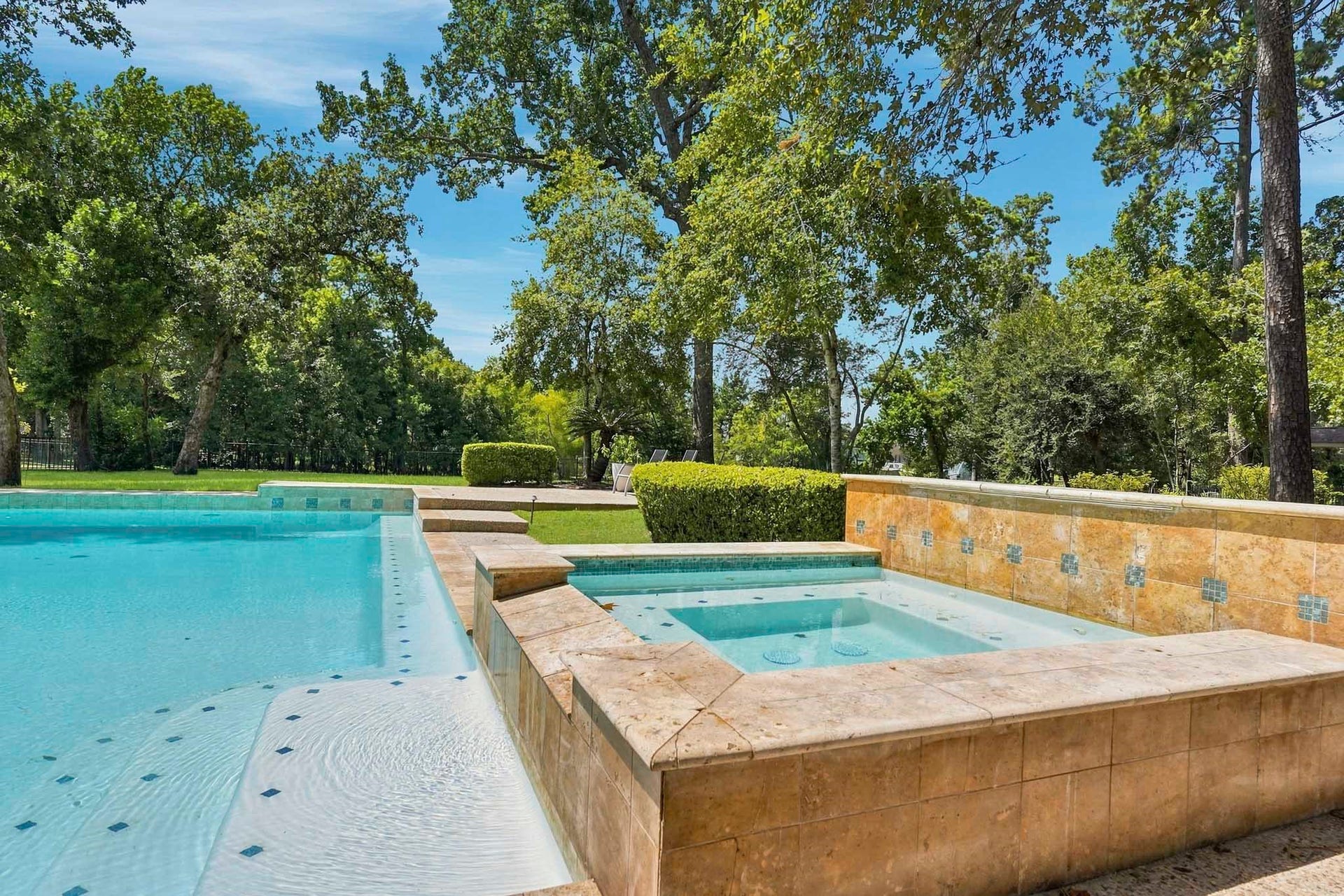 7611 Kings River Lane, Humble, TX 77346 Raised spa with water feature complements the recently resurfaced pool, creating an inviting setting for relaxation and outdoor entertaining.