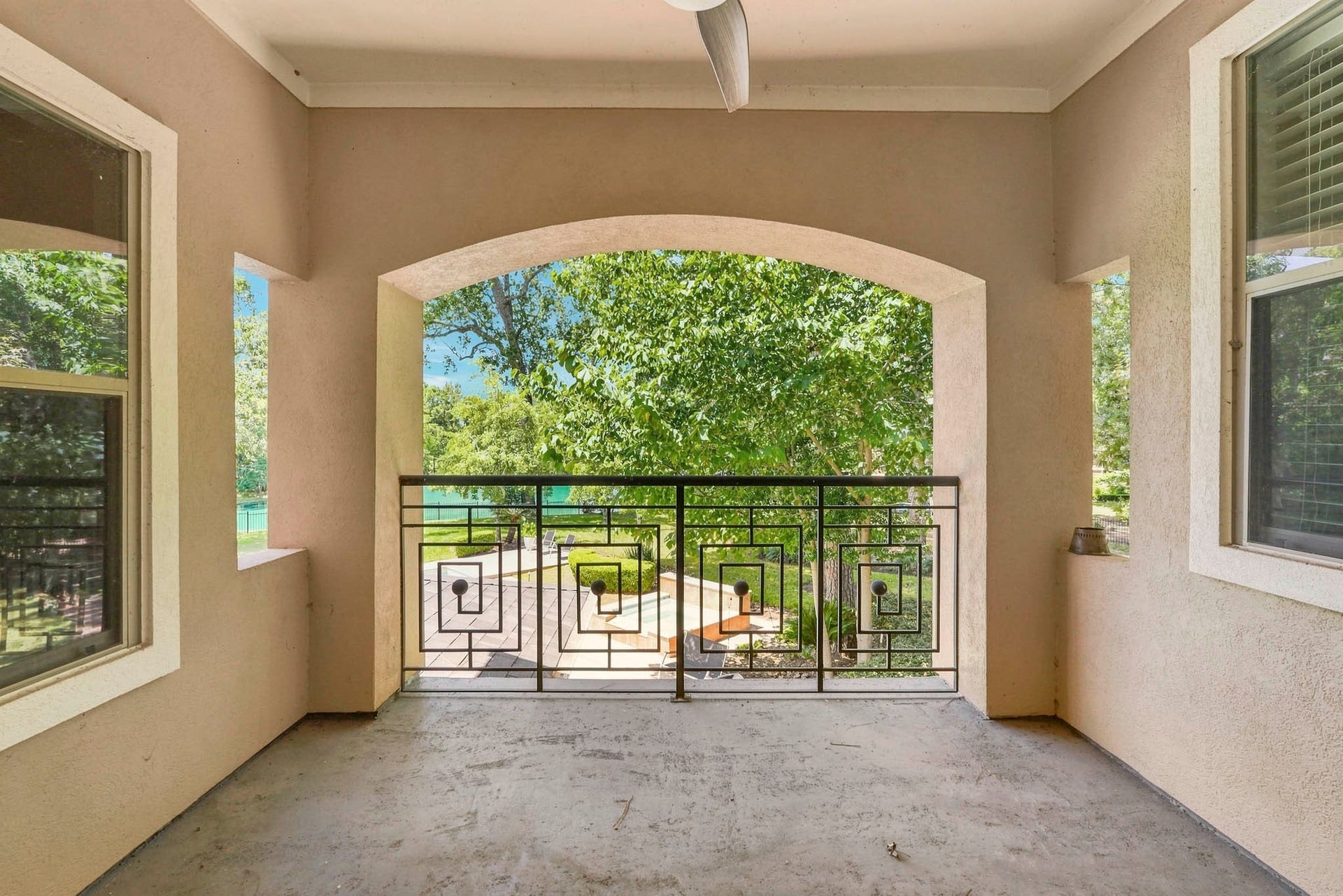 7611 Kings River Lane, Humble, TX 77346 Covered second-story balcony overlooks the pool and lake, offering elevated water views and an open connection to the outdoor living area below.