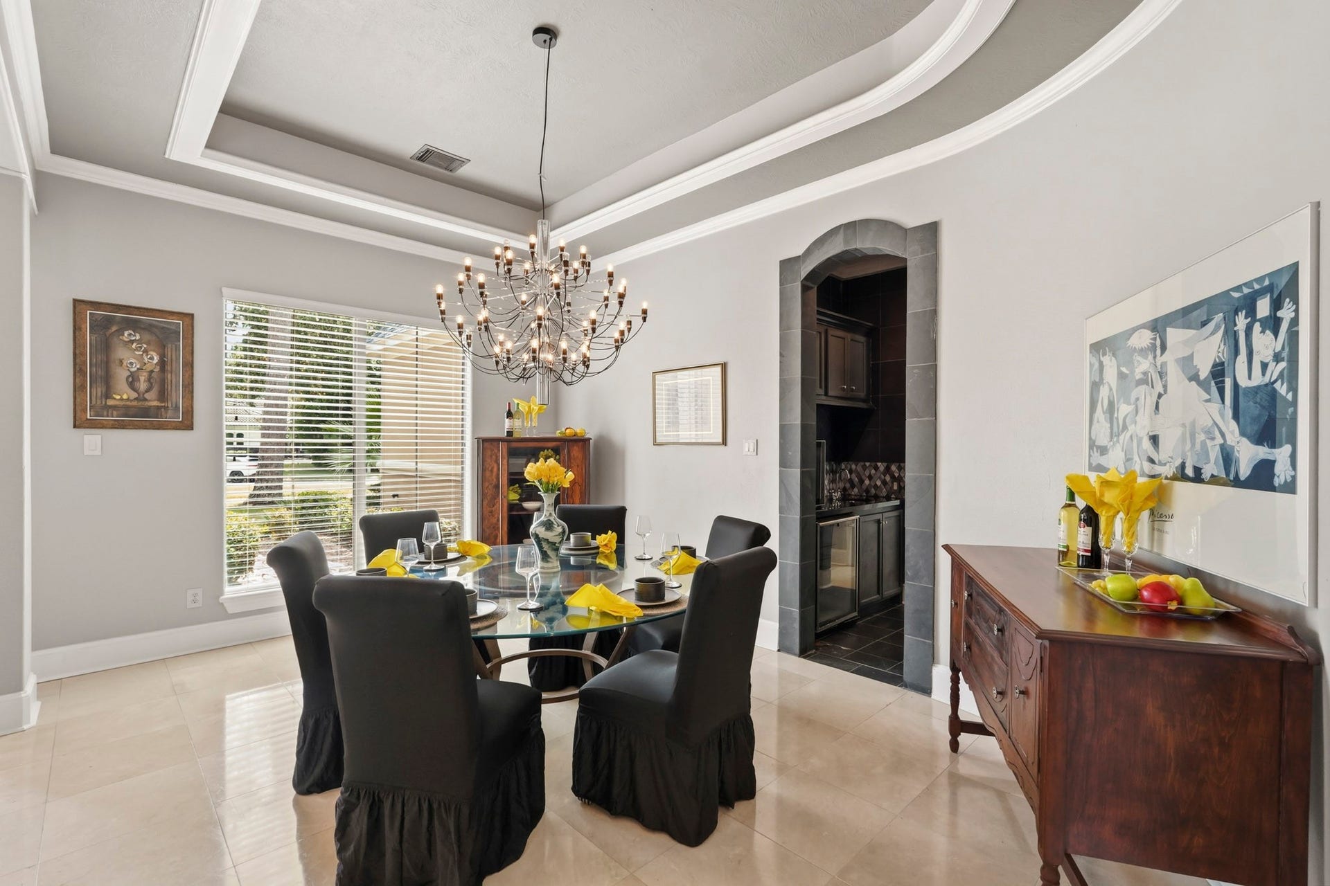 7611 Kings River Lane, Humble, TX 77346 Elegant formal dining room features a dramatic tray ceiling, extensive crown molding, chandelier, dark wood flooring and large windows overlooking the landscaped grounds.