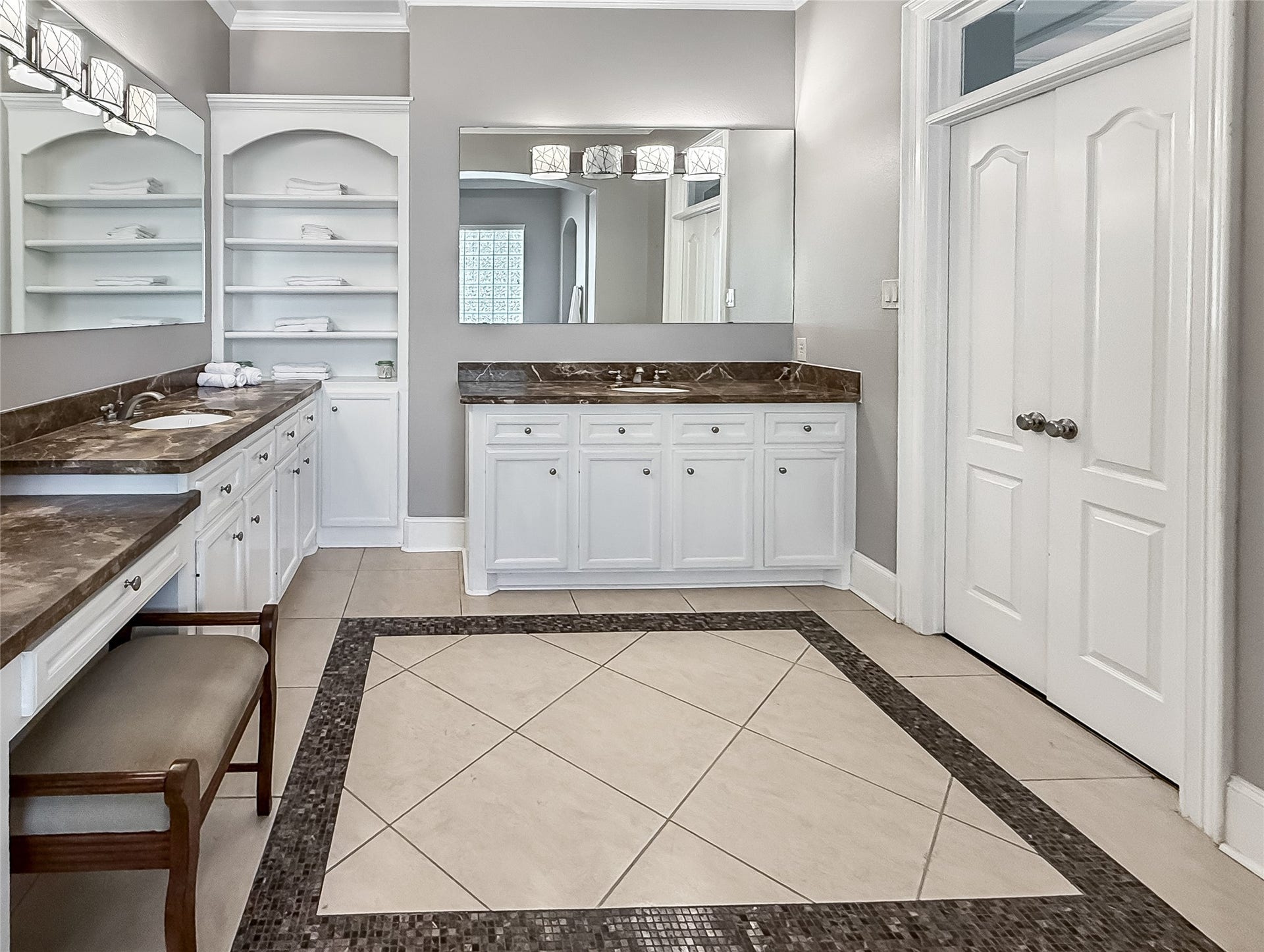 7611 Kings River Lane, Humble, TX 77346 Additional primary bath view showcases dual vanity areas, extensive cabinetry and counter space, oversized mirrors and the generous proportions of the suite.