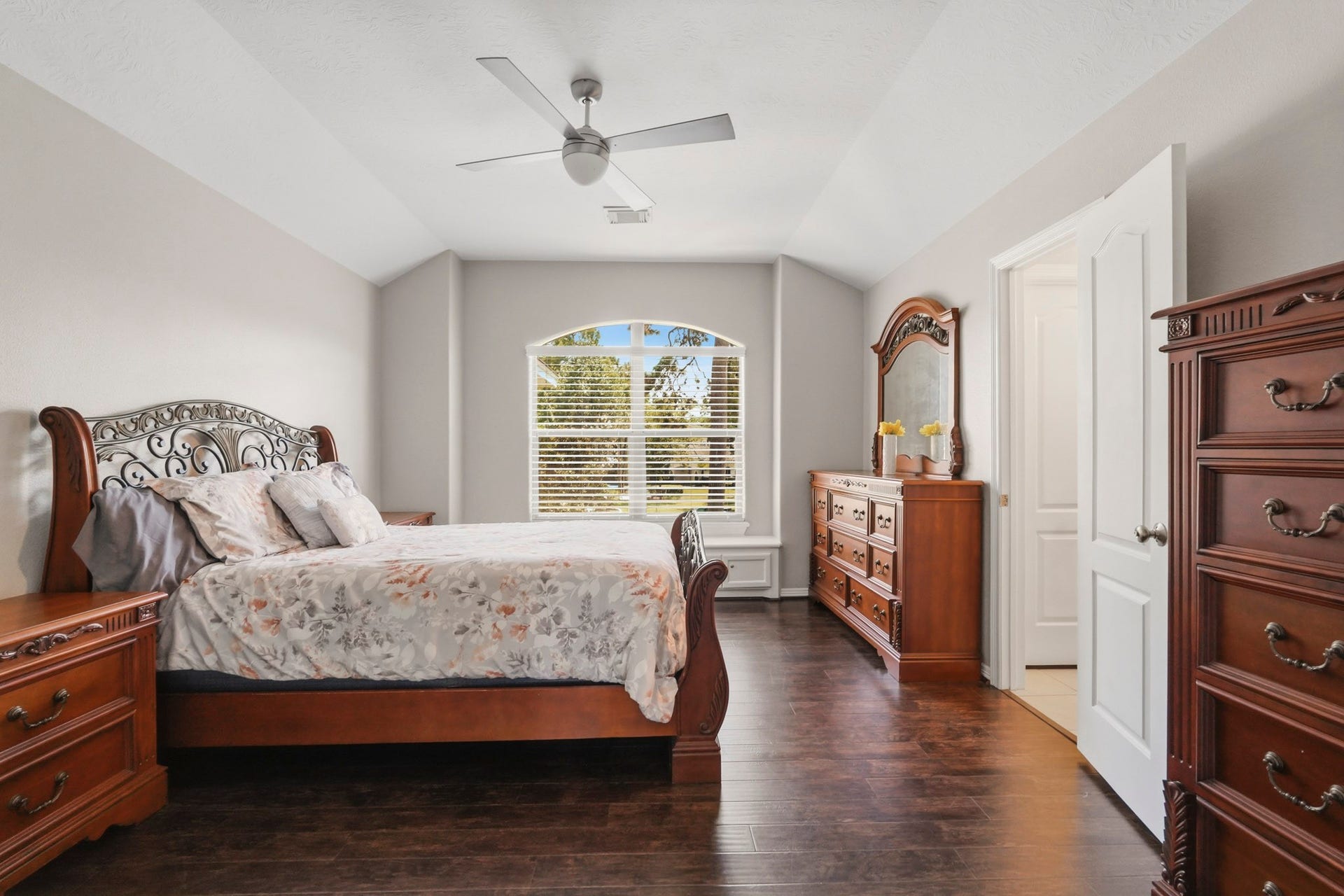 7611 Kings River Lane, Humble, TX 77346 Spacious secondary bedroom features rich wood flooring, crown molding, ceiling fan and multiple windows providing abundant natural light.