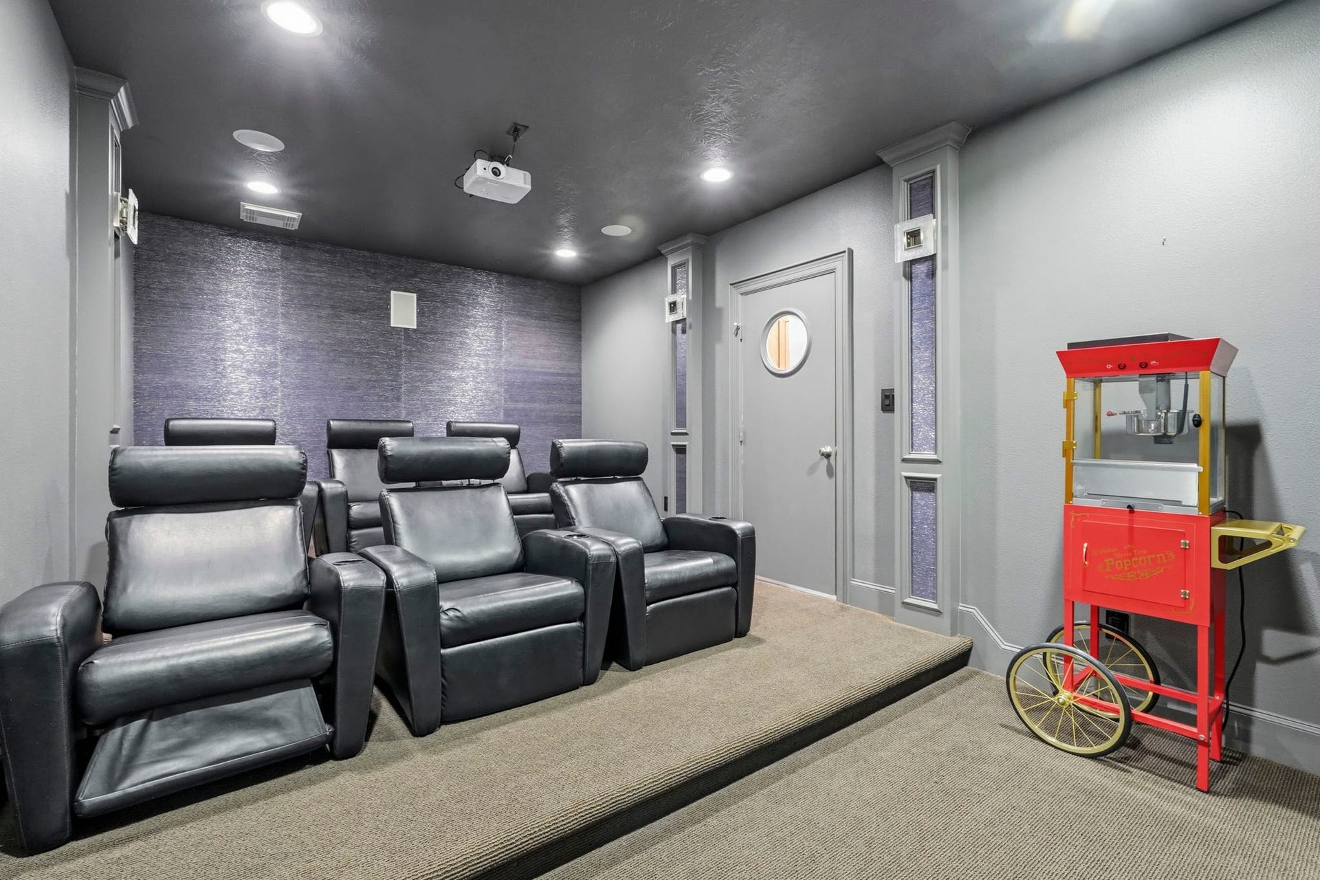 7611 Kings River Lane, Humble, TX 77346 Dedicated home theater features a projection screen, projector and tiered theater seating for an authentic movie-night experience.