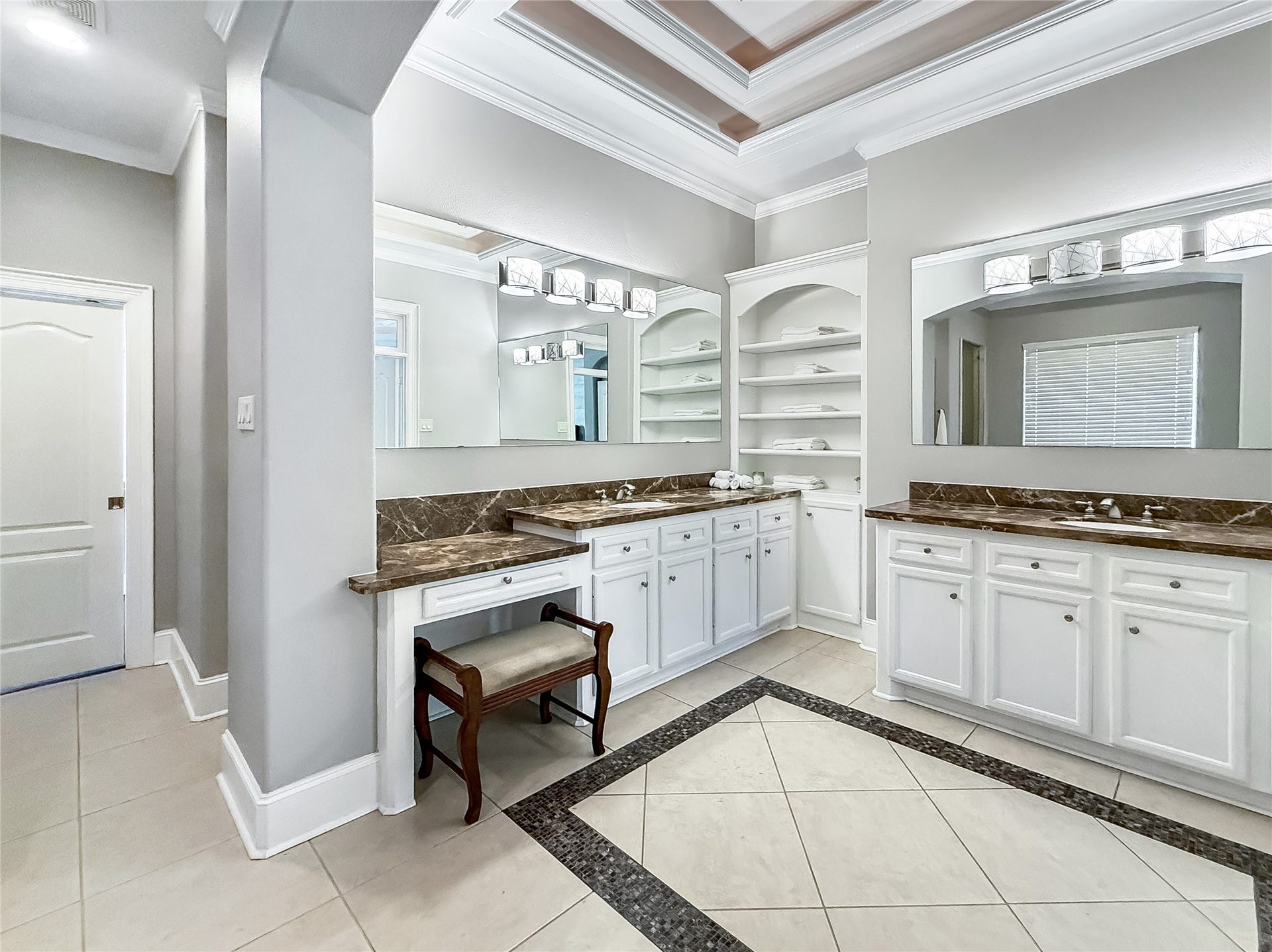 7611 Kings River Lane, Humble, TX 77346 Expansive primary bath features his-and-hers sinks, his-and-hers closets, granite countertops, extensive cabinetry and oversized mirrors, offering exceptional space, storage and functionality.
