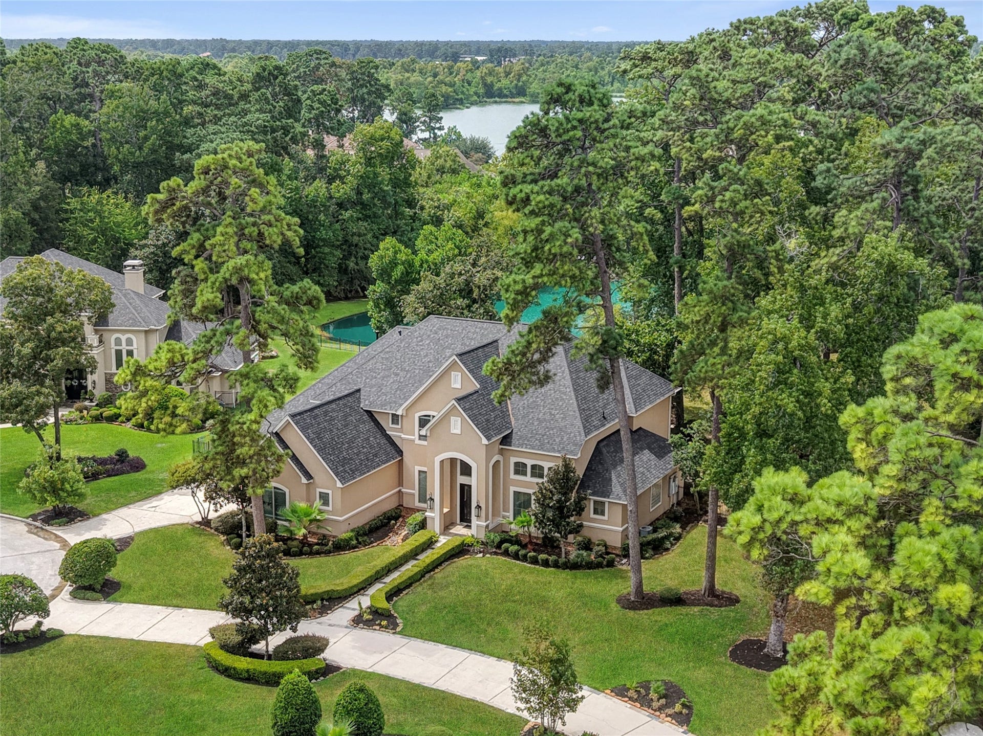 7611 Kings River Lane, Humble, TX 77346 Aerial perspective showcases the residence nestled among mature trees on an expansive approximately 1.33-acre homesite.