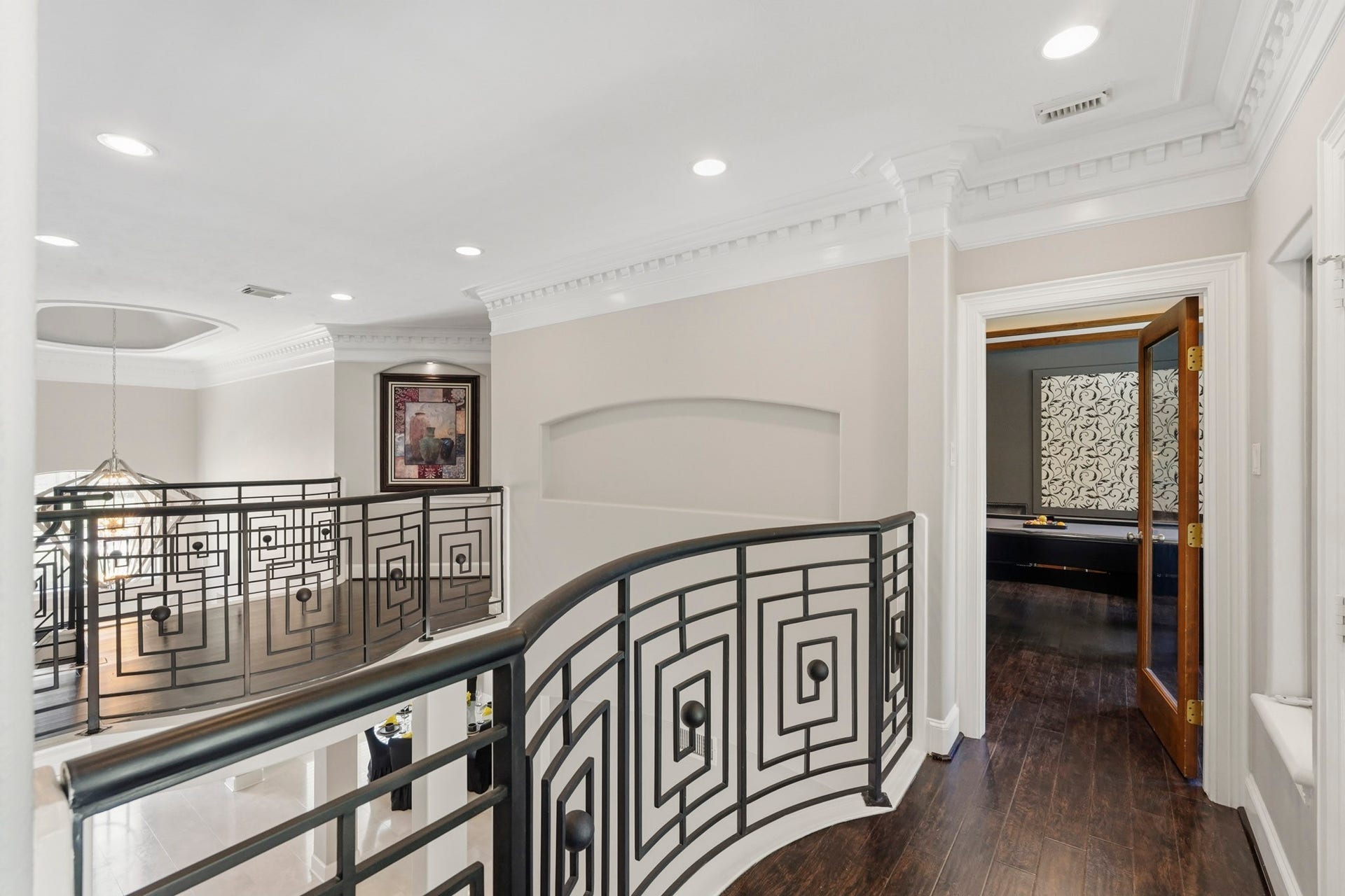 7611 Kings River Lane, Humble, TX 77346 Open second-story gallery features decorative iron railing, architectural detailing and views overlooking the main level.