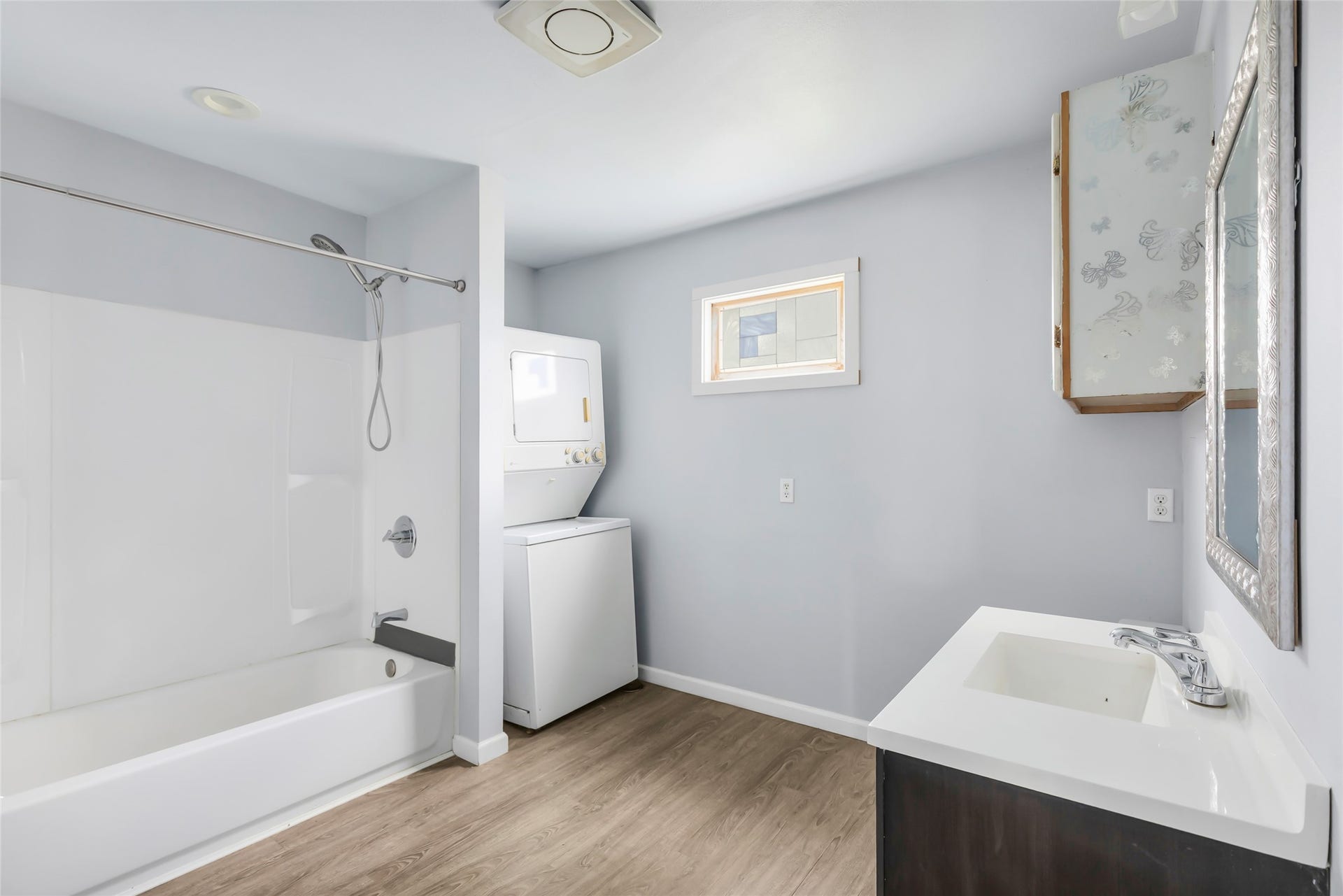 17659 E FM 1097 ROAD, Willis, TX 77378 SMALL HOME - VIEW OF BATHROOM, TUB WITH SHOWER & UTILITY ROOM WITH STACKABLE WASHER & DRYER...