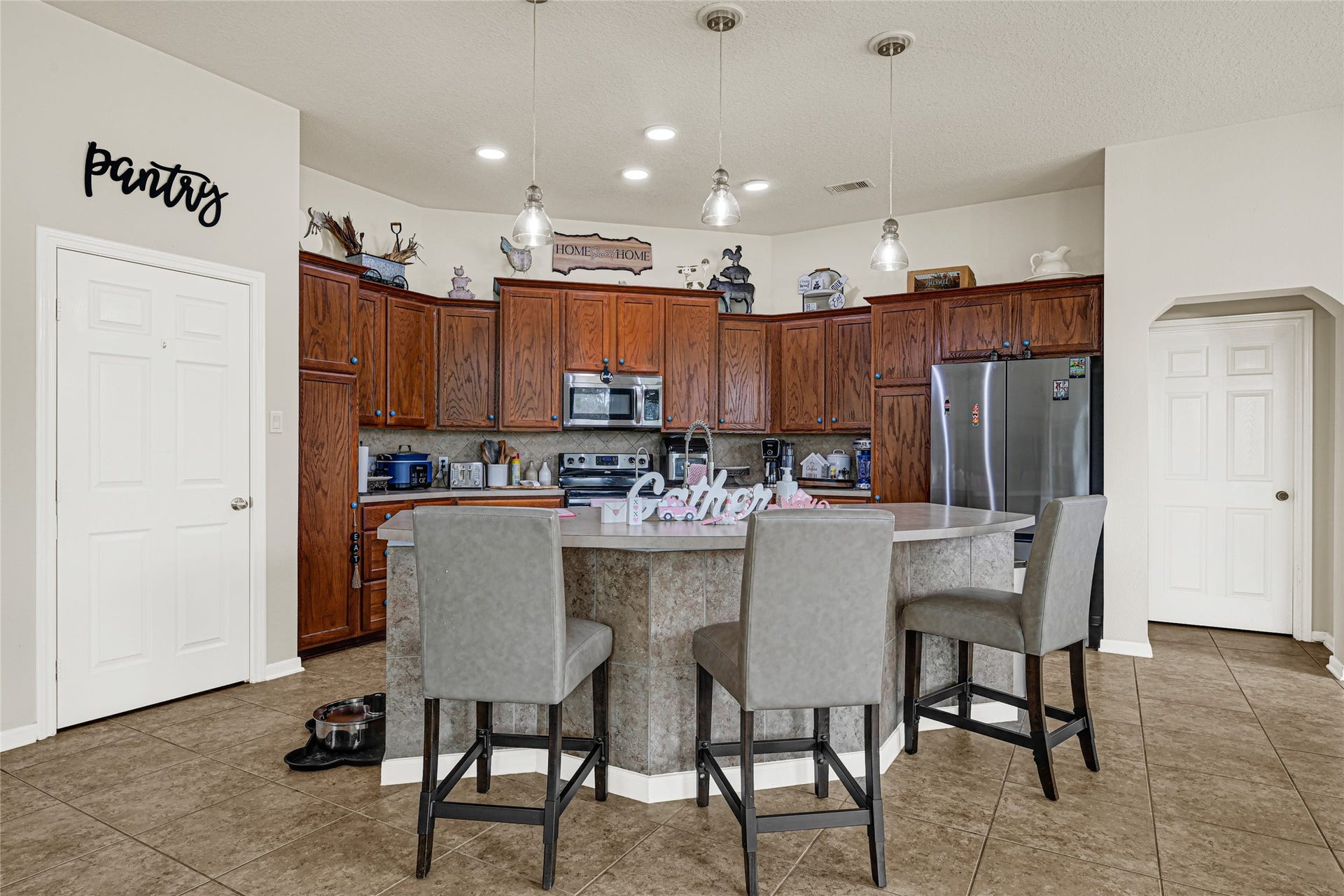 Open-concept kitchen with ample cabinetry, generous counter space, and breakfast bar seating.