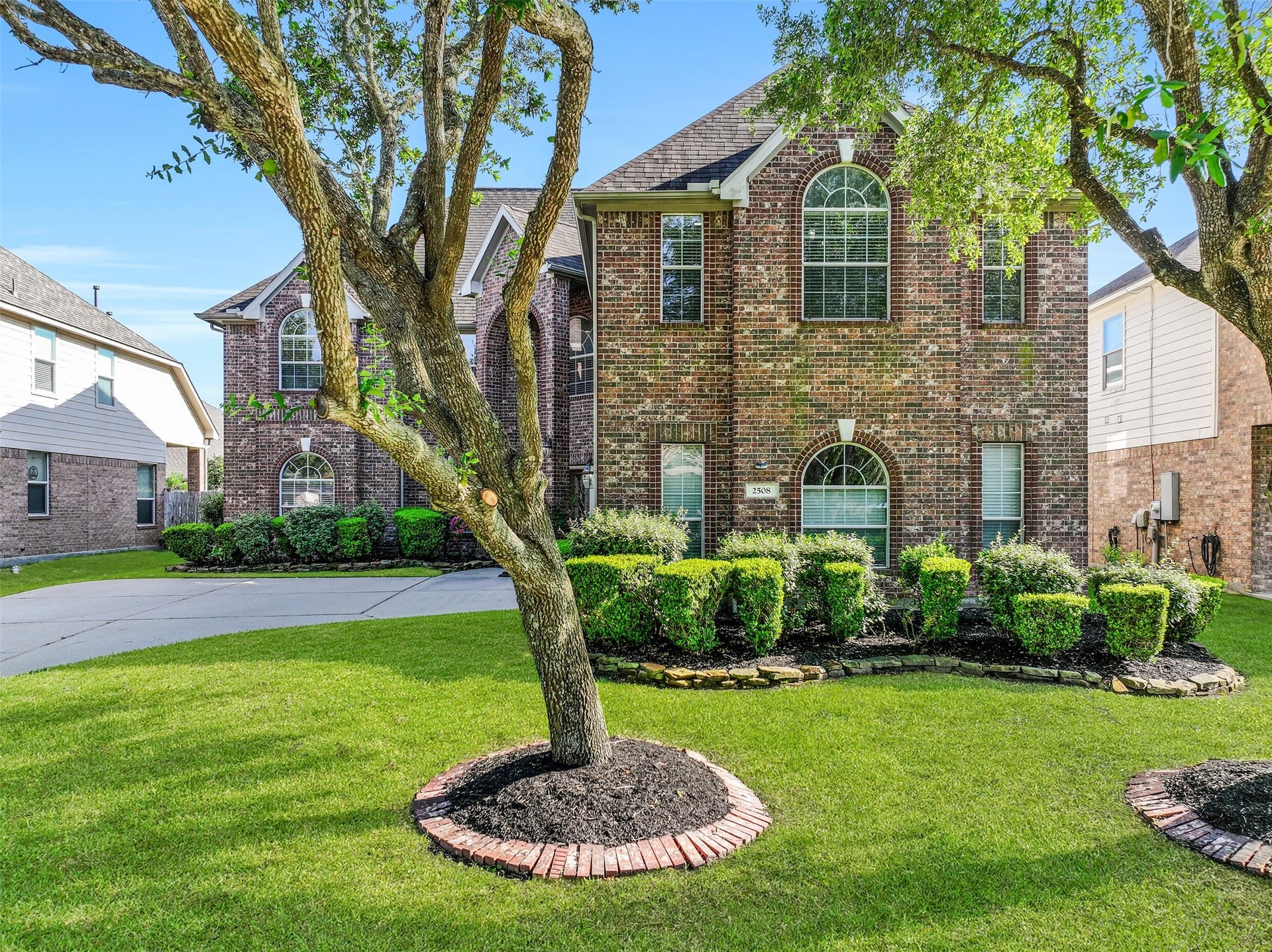 2508 Rockygate Lane, Friendswood, TX 77546 Welcome to 2508 Rockygate Lane in the Stonecreek section of Friendswood's sought-after West Ranch community! Nestled beneath mature shade trees, this impressive Village Builders home showcases a stately brick elevation, manicured landscaping, an in-ground sprinkler system, and fresh exterior paint for outstanding curb appeal.